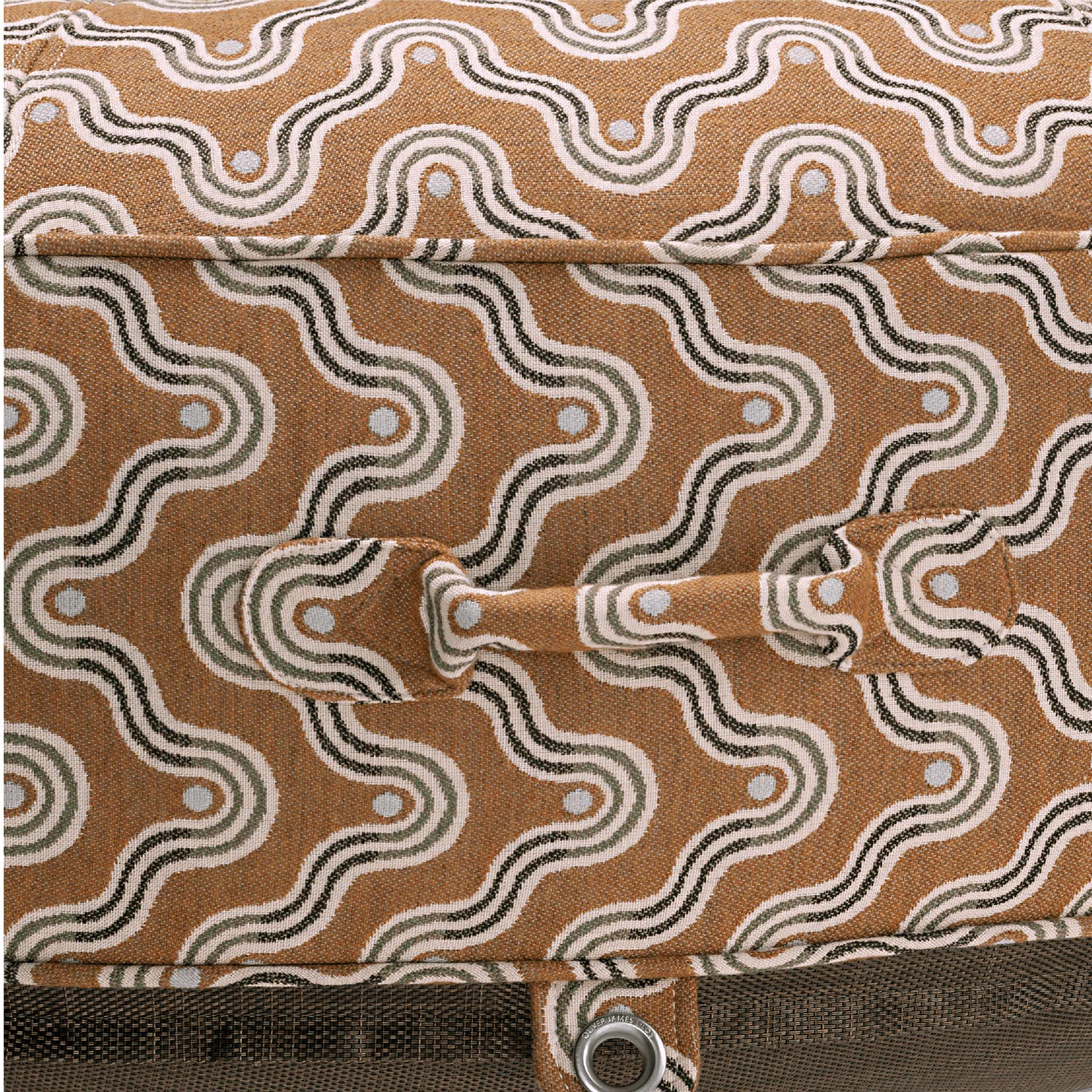 Close-up of pool float showing brown block-print-inspired handle, earthy weave texture, and stainless eyelet