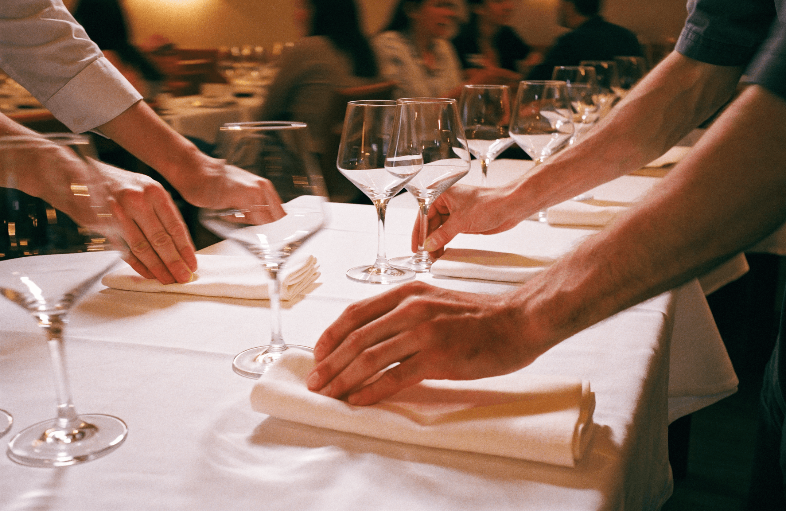 Restaurant team resetting tables for the next guests