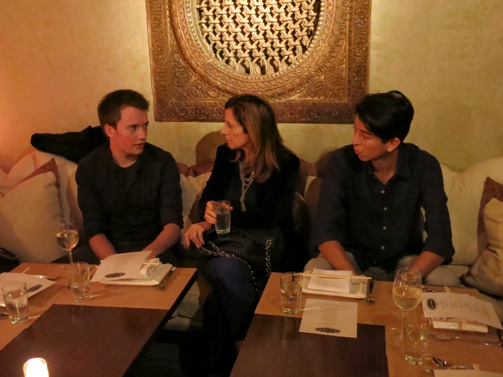 people chatting while they are sitting at a dining table in a restaurant