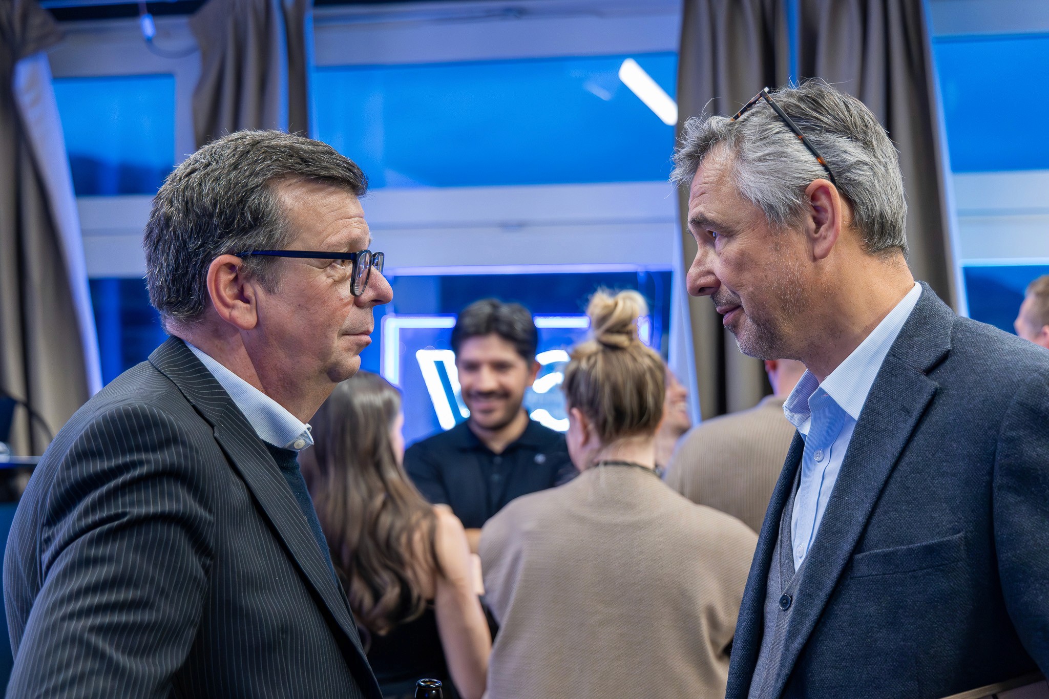 Guests networking during a blockchain event photographed by Mizuri