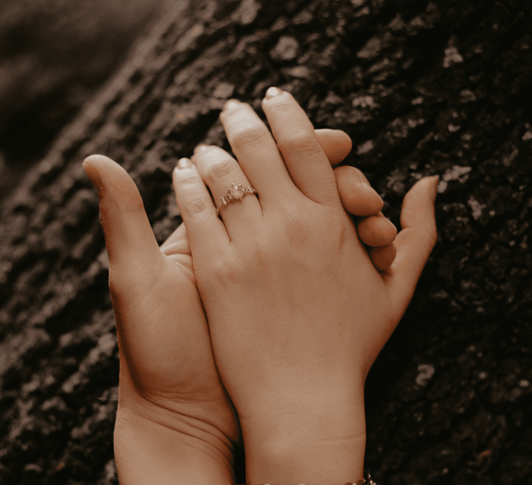 Two gold wedding rings rest atop a soft, textured fabric with a subtle pattern. The rings shine under gentle light, evoking themes of love and commitment.