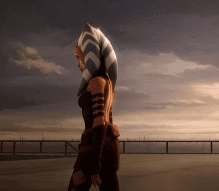 Ahsoka Tano walking away on a platform in front of a setting sun