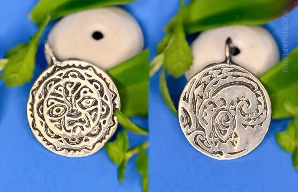 photograph of a cast silver pendant of a polynesian tribal face front and back