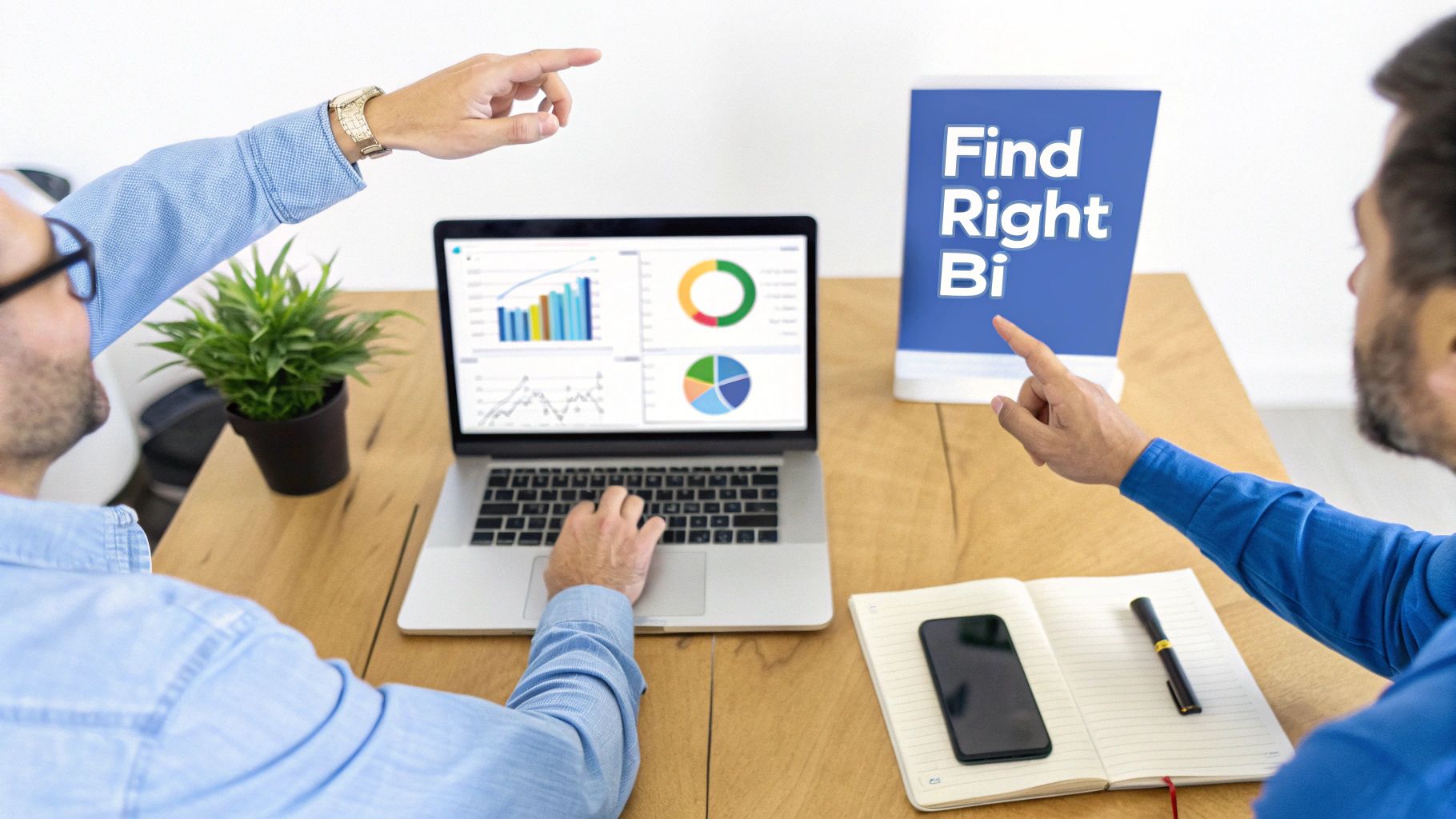 Two men collaborating on business intelligence, one typing on a laptop showing data charts and graphs.