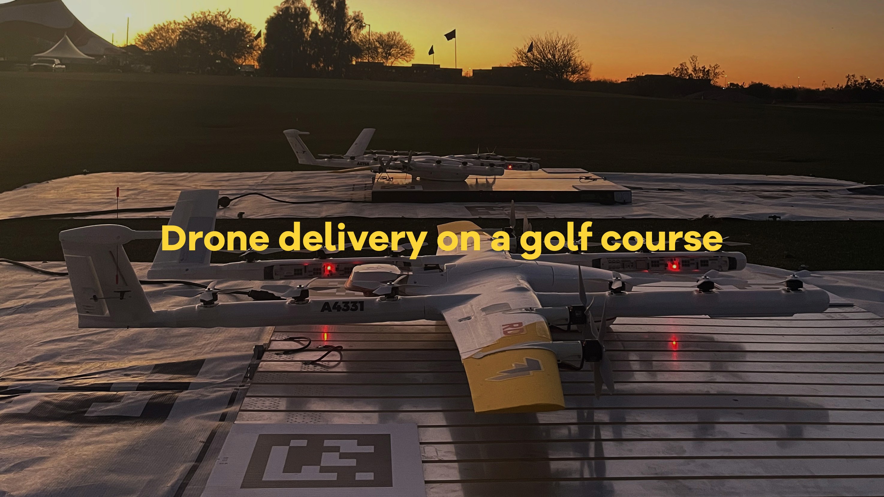 A drone designed for delivery rests on a neatly manicured golf course at sunset, highlighting the integration of technology in recreational spaces.