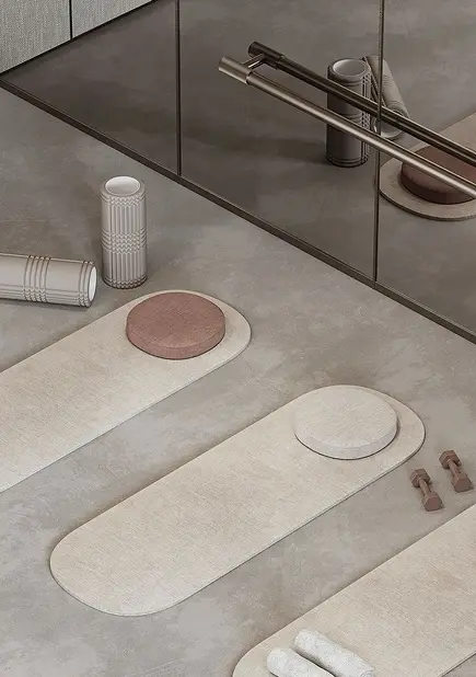 A serene spa setting featuring beige yoga mats, foam rollers, and light weights on a smooth concrete floor, reflecting a wellness theme.