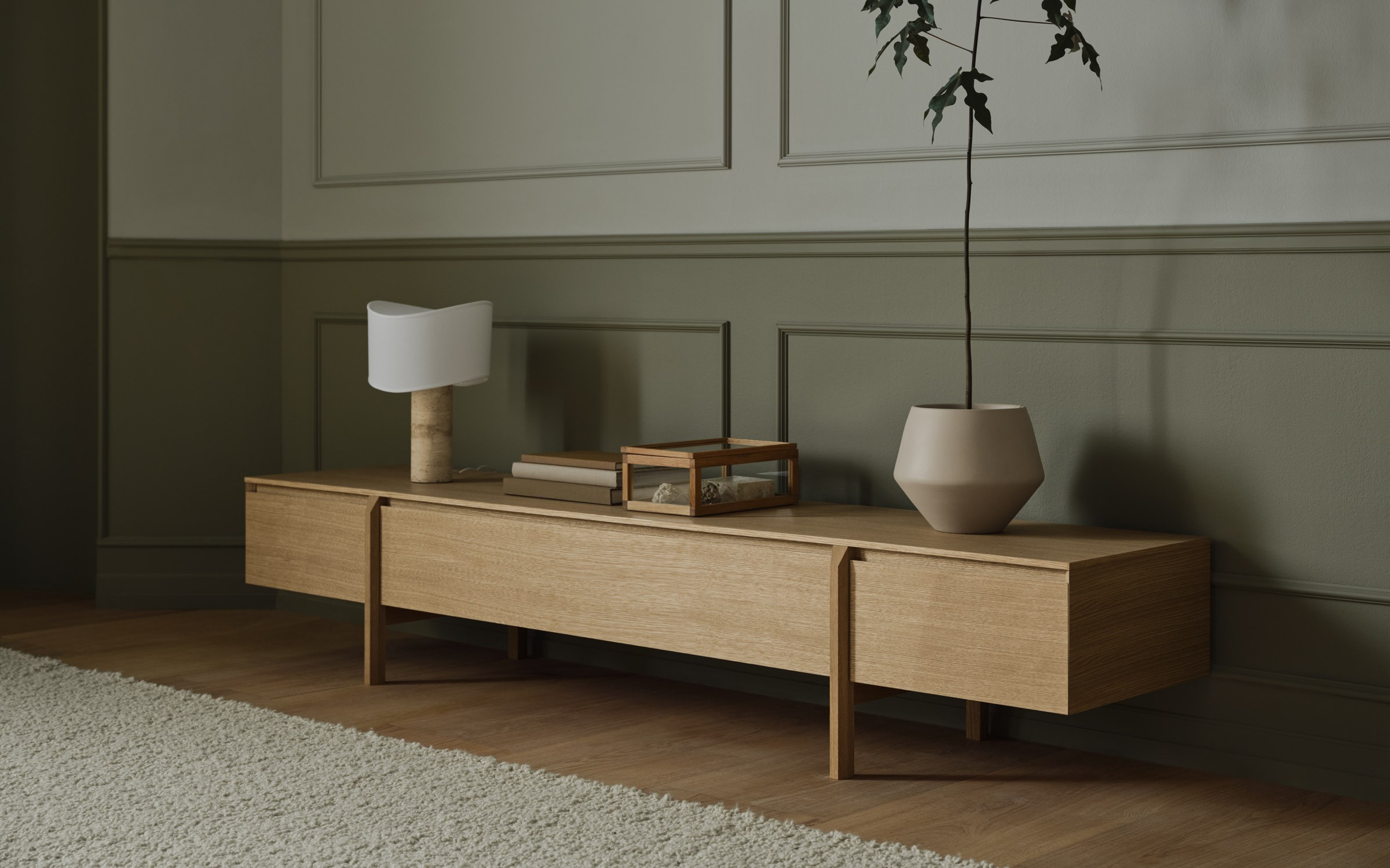 Tajo table lamp in white with stone base placed on wooden sideboard in calm interior designed by Asger Risborg Jakobsen