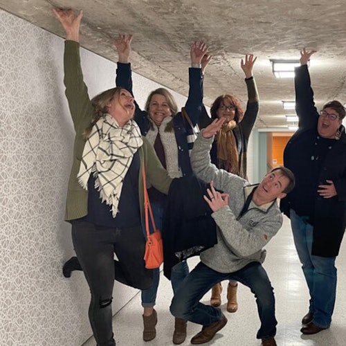 Guests enjoy a fun group photo inside the rustic tunnel during the Astroville Tunnel Tour of Downtown Houston.