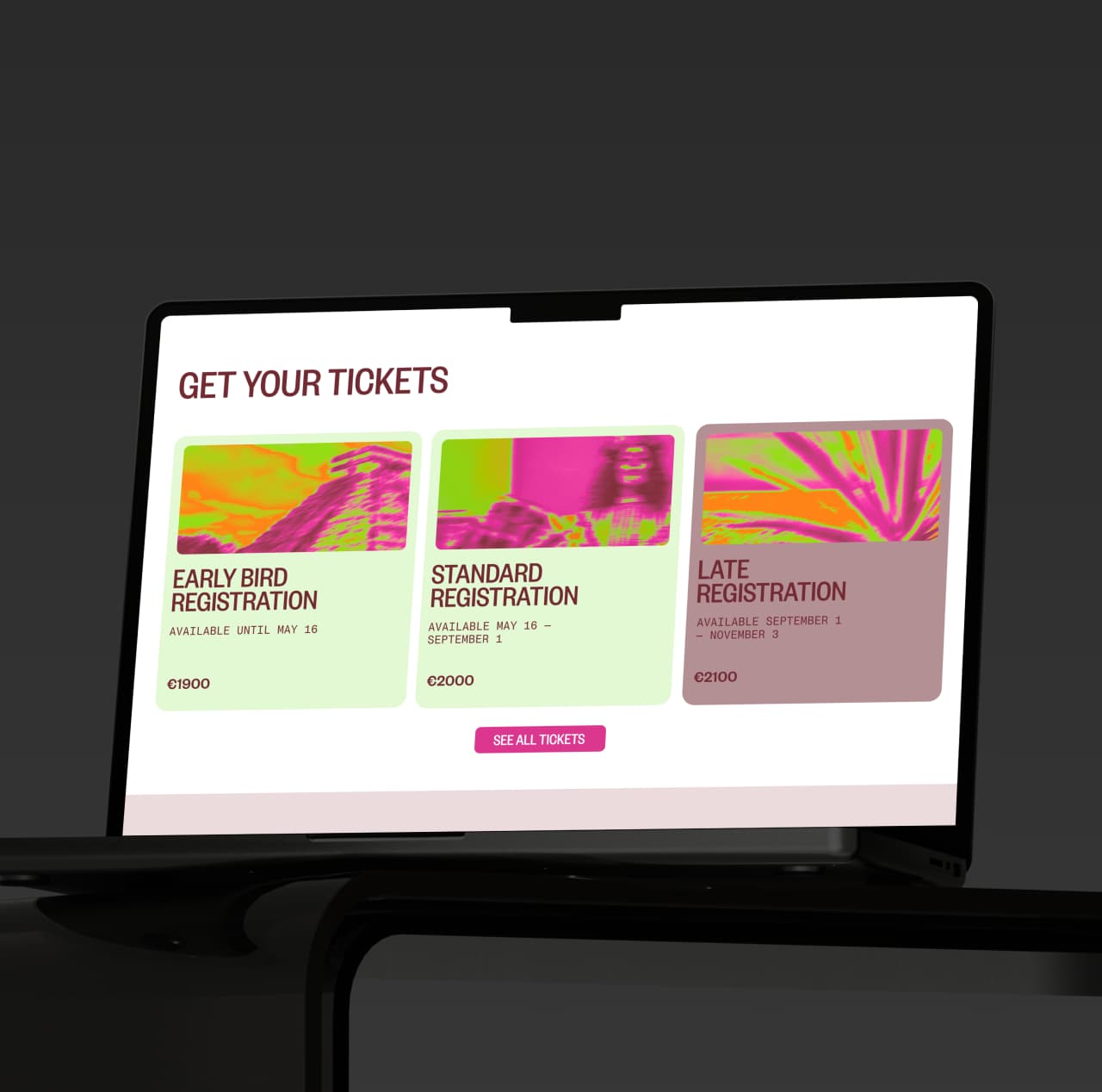 Laptop screen showing the IDC 2026 tickets section with early bird, standard, and late registration cards using magenta and lime event artwork