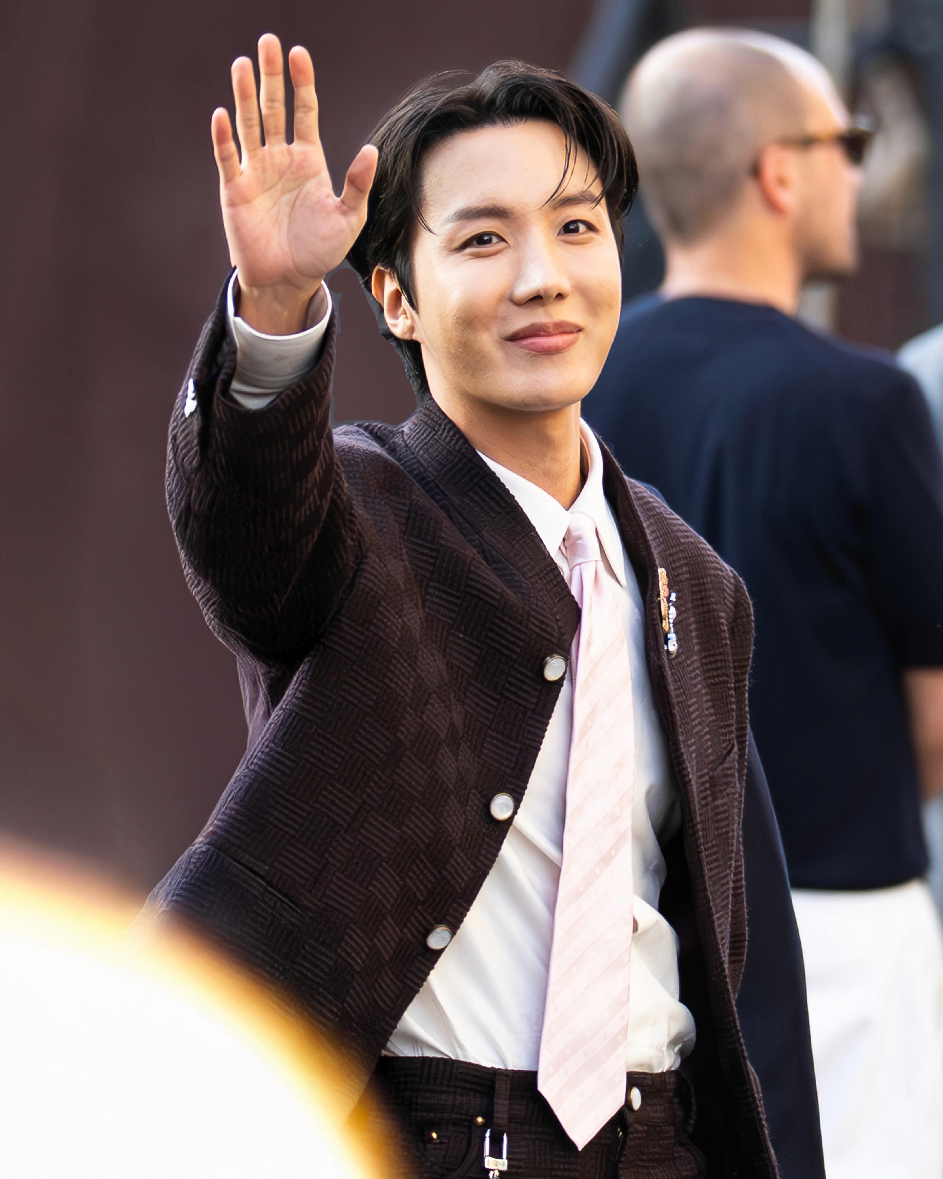 J-Hope of BTS waves to fans at the Louis Vuitton Men's Spring-Summer 2026 show at Paris Fashion Week.