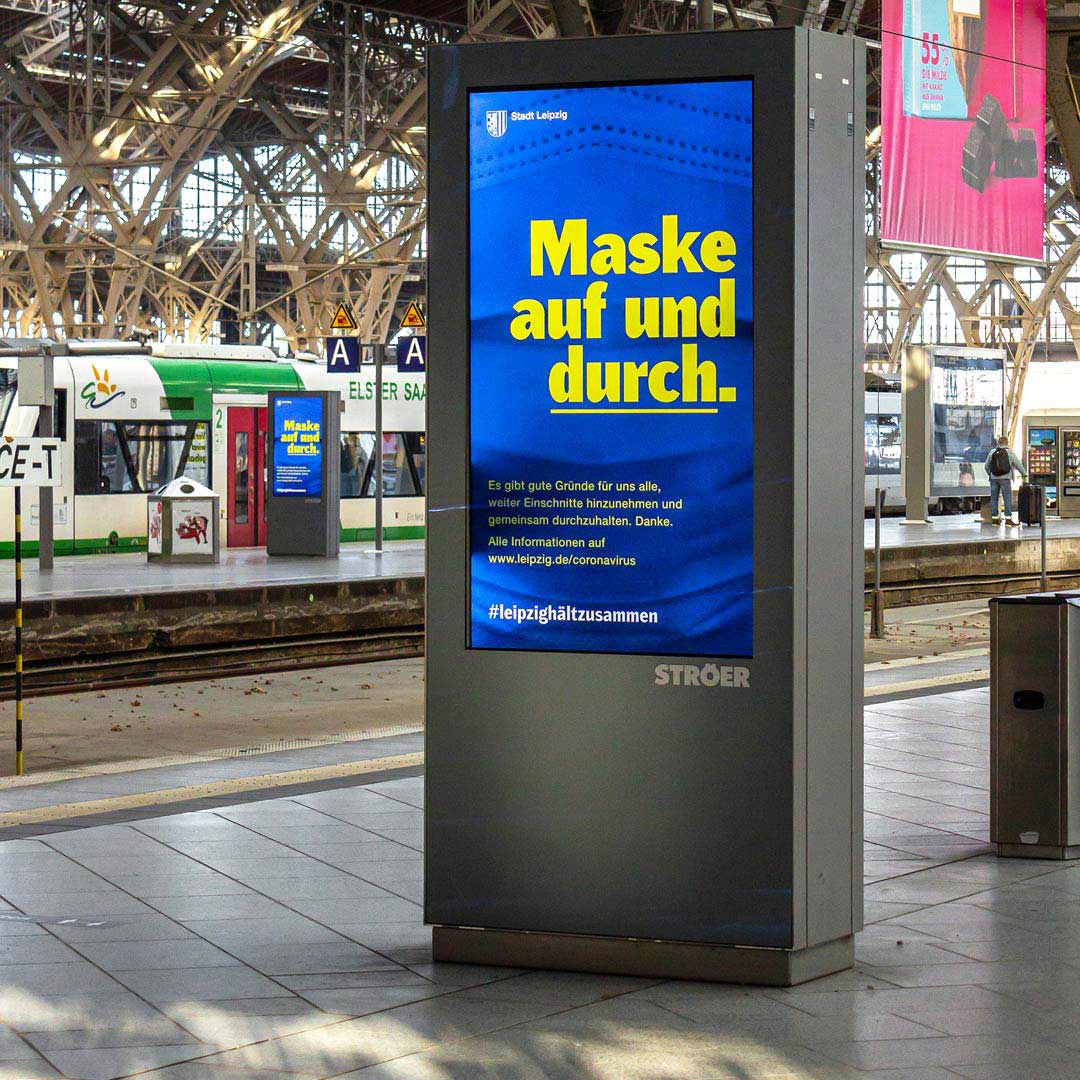 photo of a backlight advertisement containing Kanton Gothic set in a big yellow headline on blue background