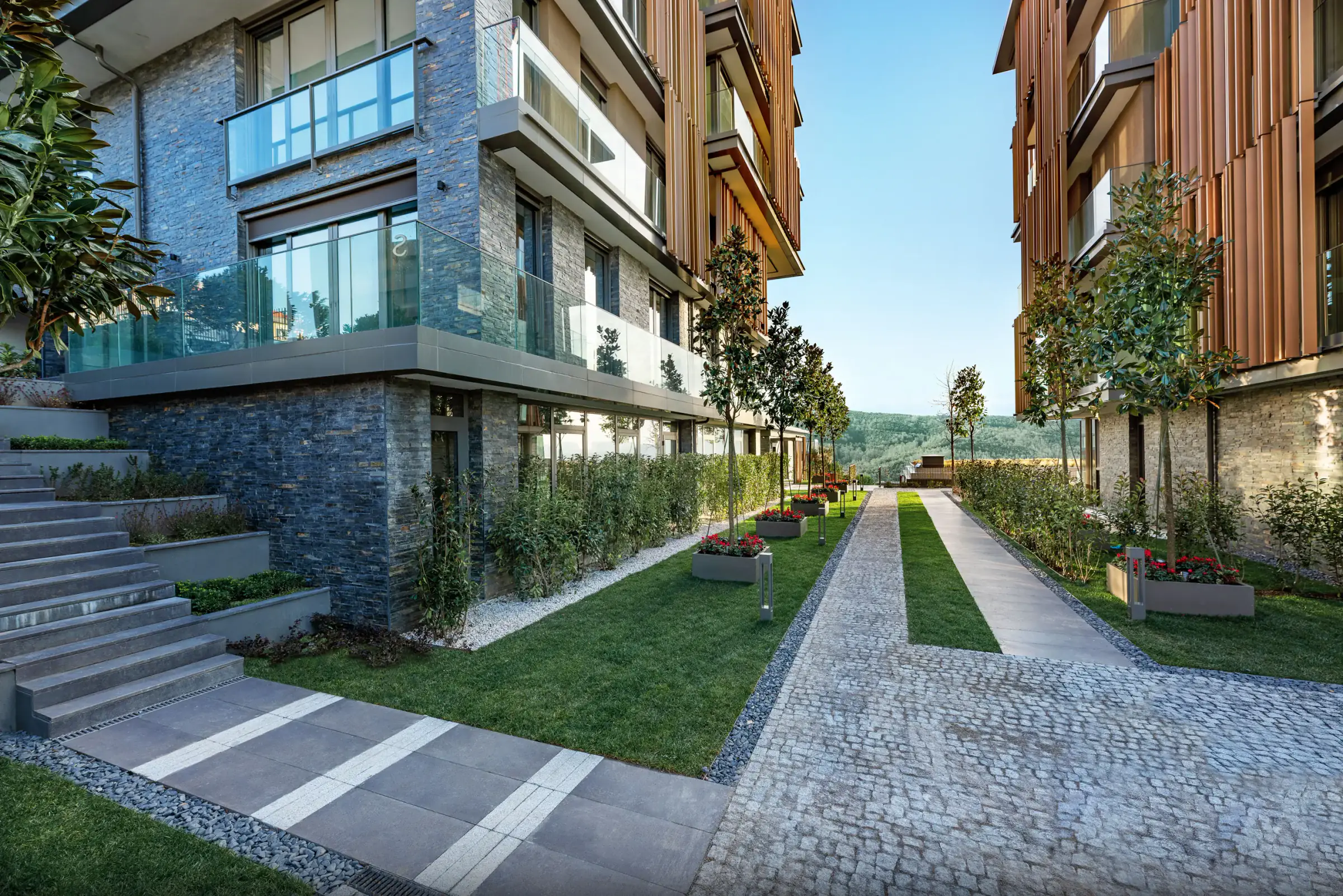 Stone-paved path and lawn between the blocks
