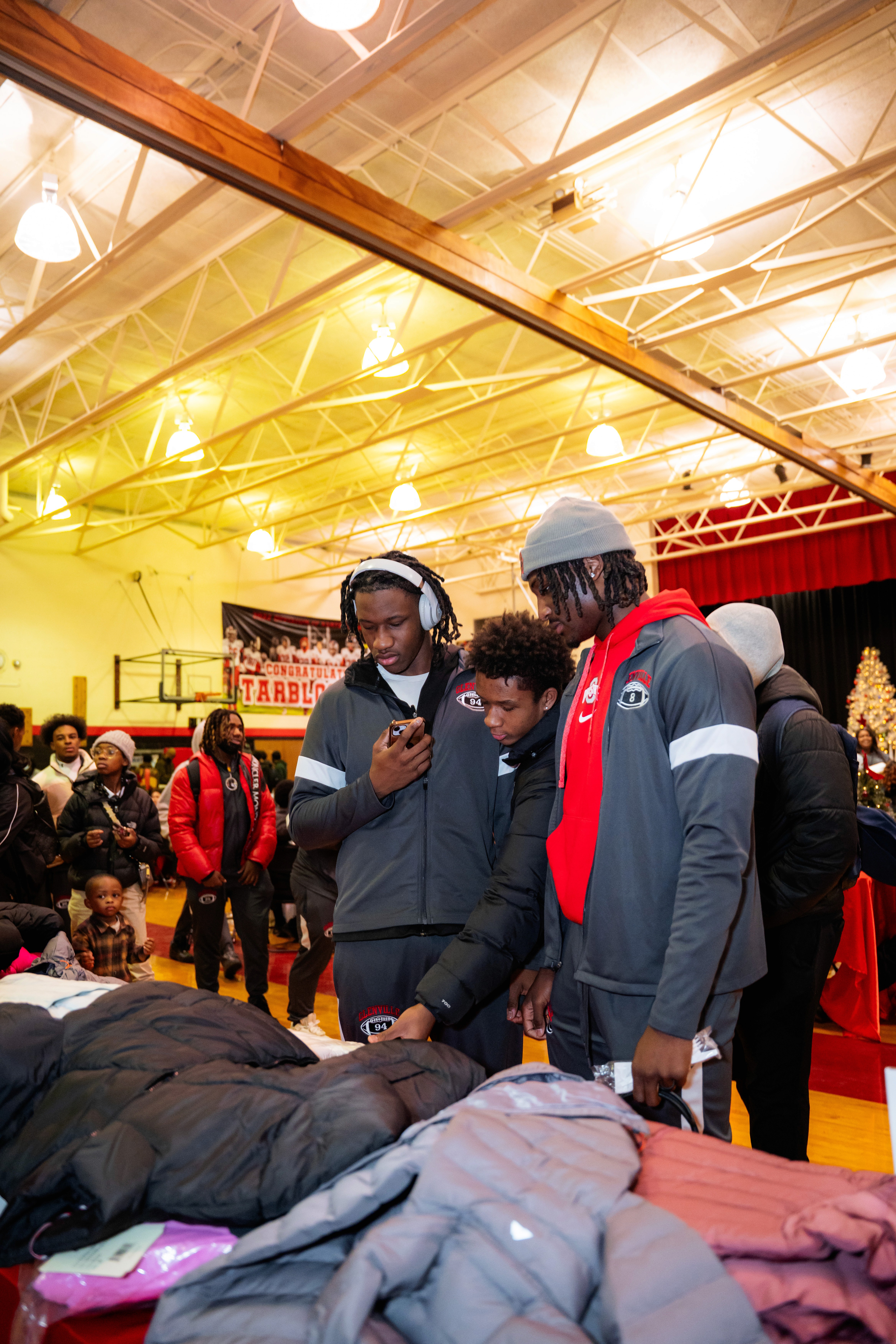 man in black crew neck t-shirt and blue shorts holding woman in white and red
