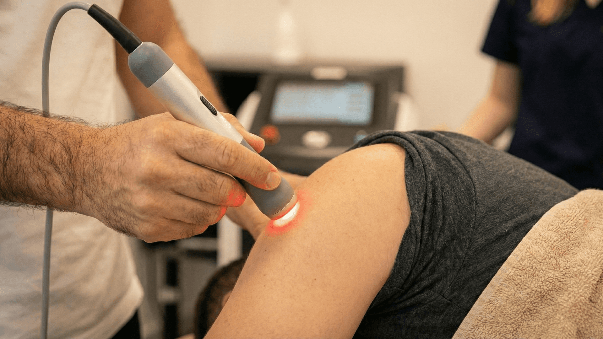 woman in orange long sleeve shirt sitting beside table with macbook pro
