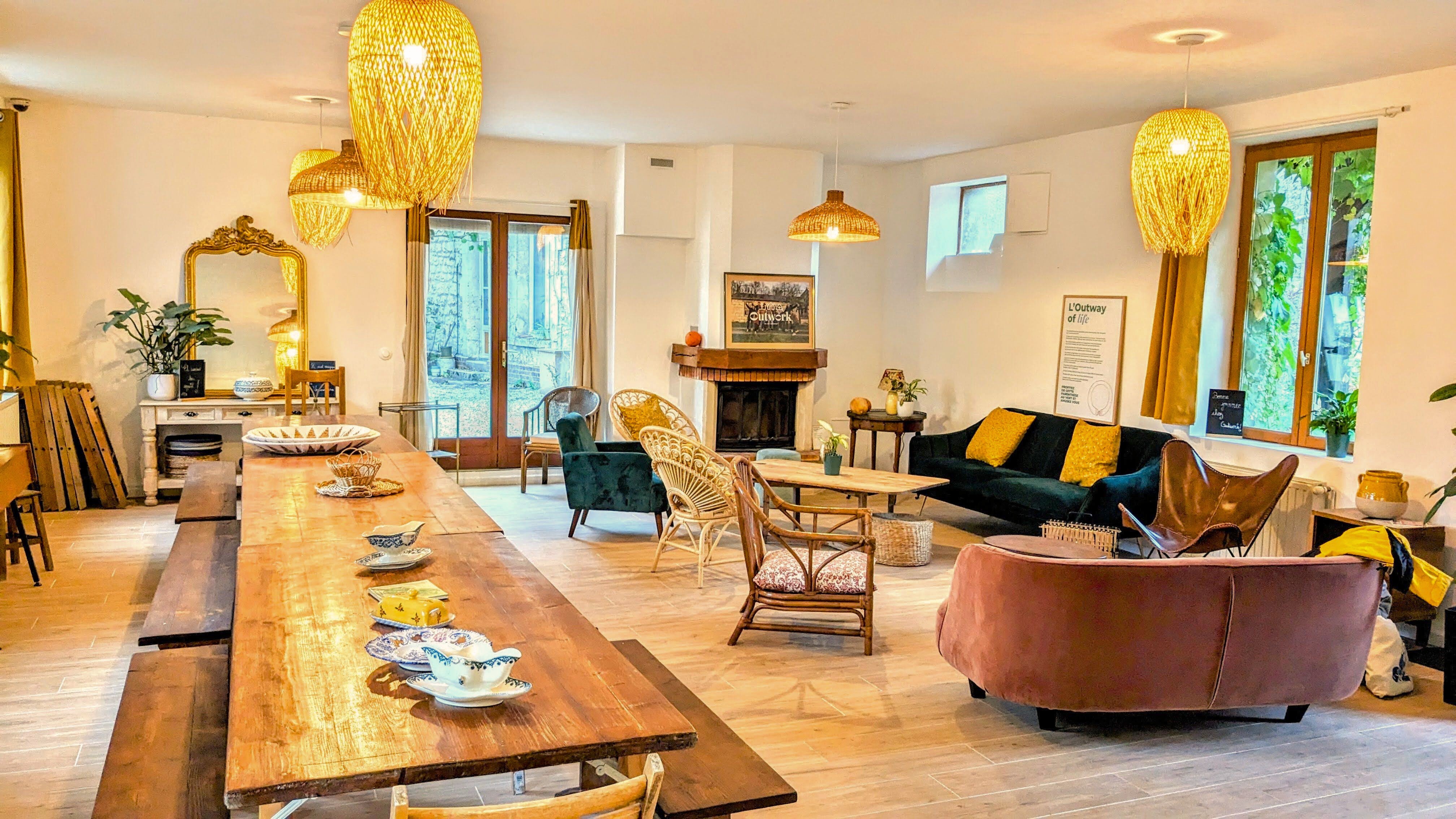Salle de vie avec une grande table à manger pour de grands groupes et un salon confortable pour se retrouver.