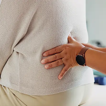 Chiropractor adjusting the lower back of a patient. 