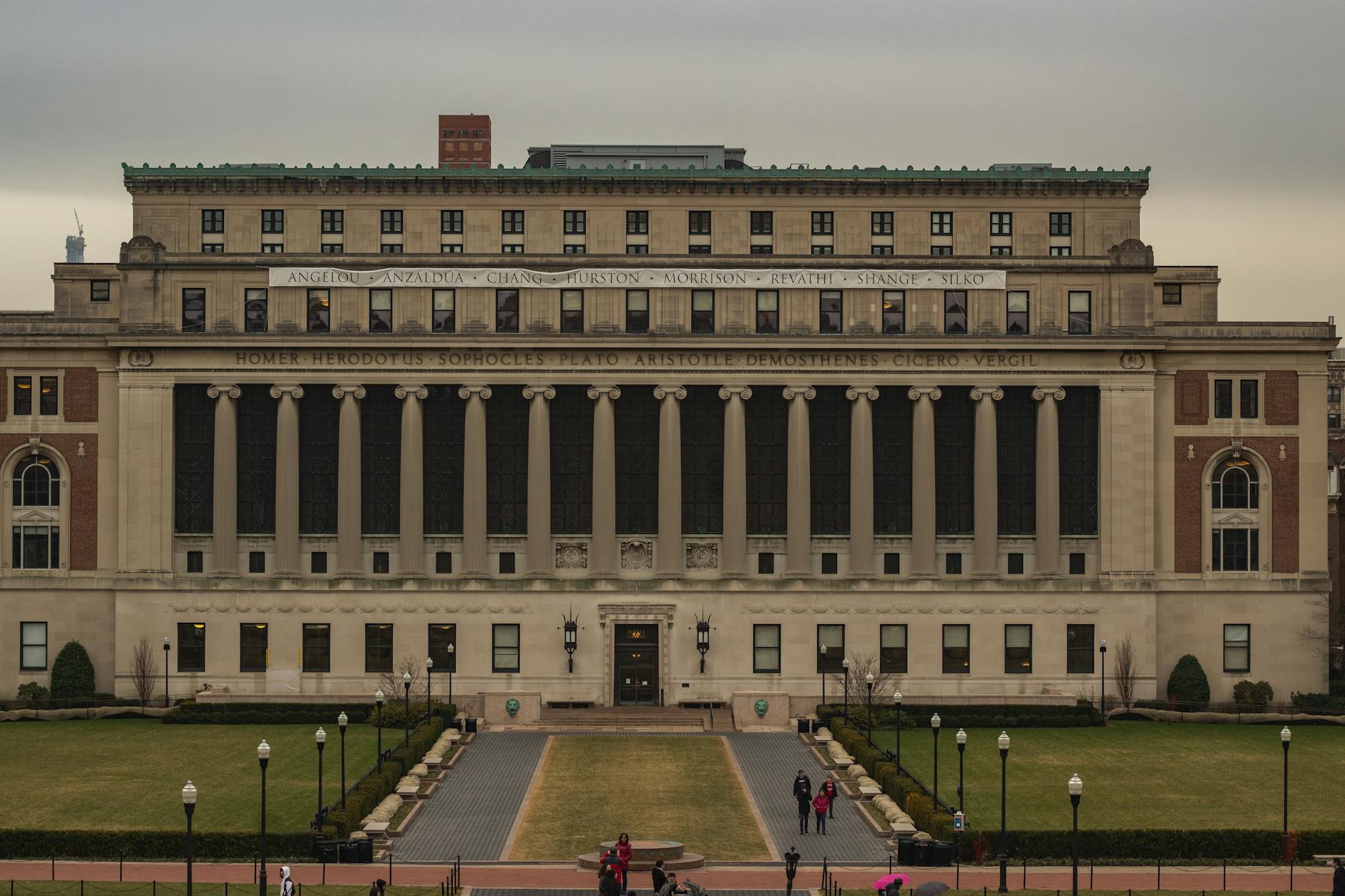 A person browsing a digital directory of accredited schools for teacher programs on a tablet at a coffee shop.