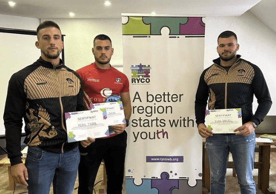 rugby players at education with certificates