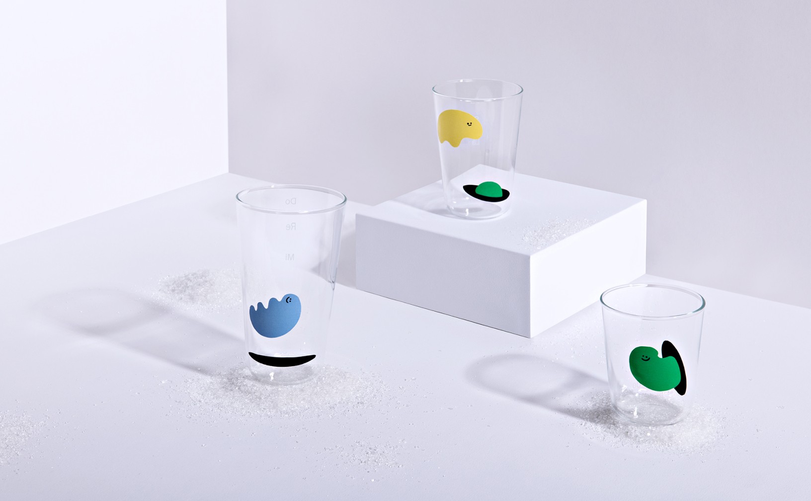 Three glass cups with printed illustrations