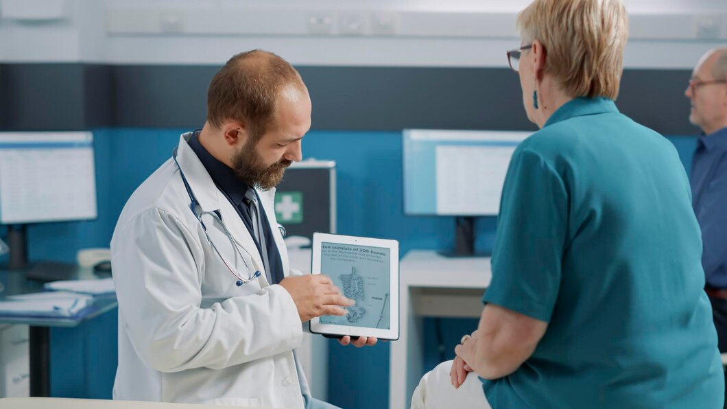 A doctor sharing a screen with the nurse for better understanding.