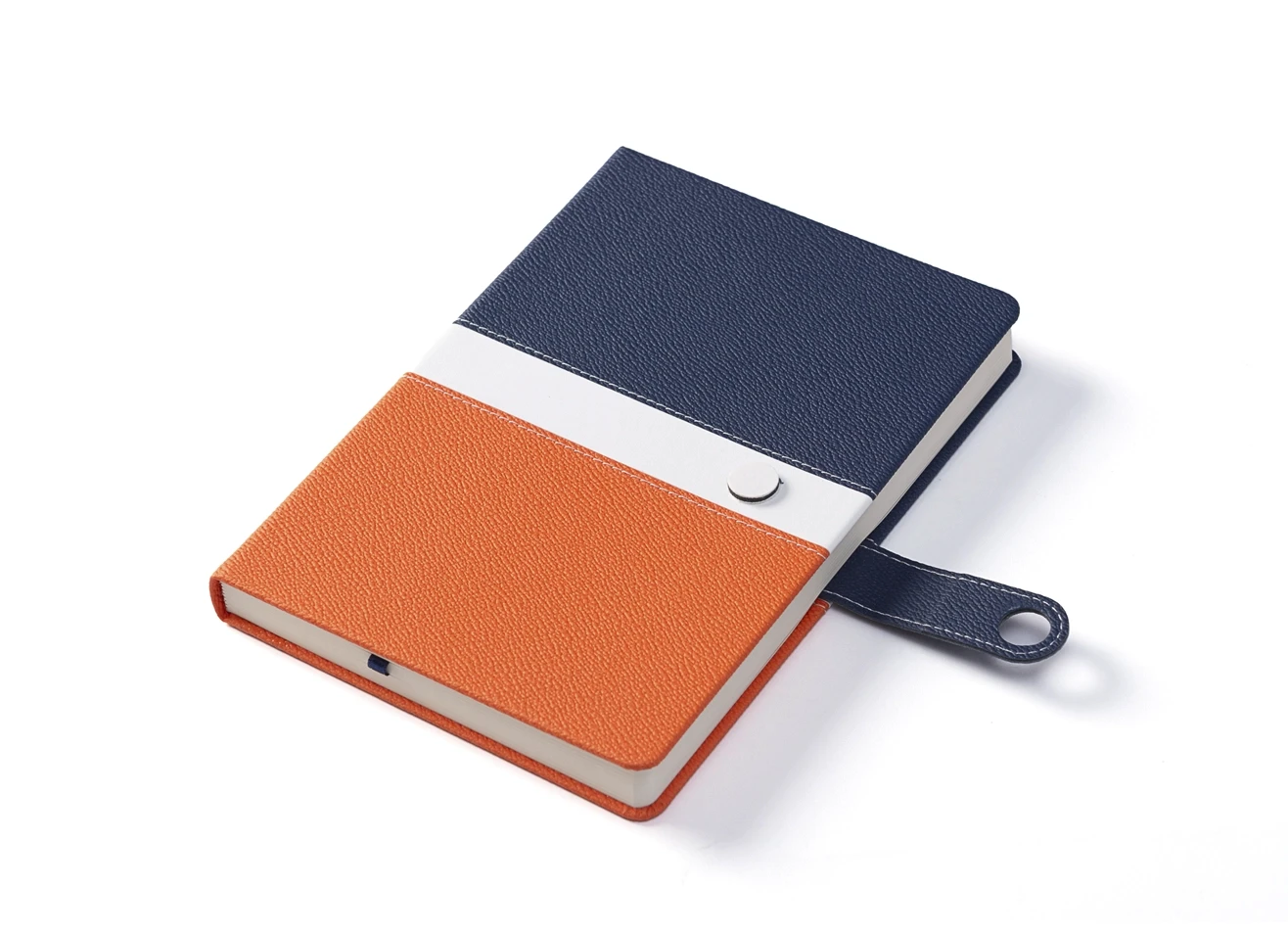 Angled view of blue and orange notebook with open snap strap.
