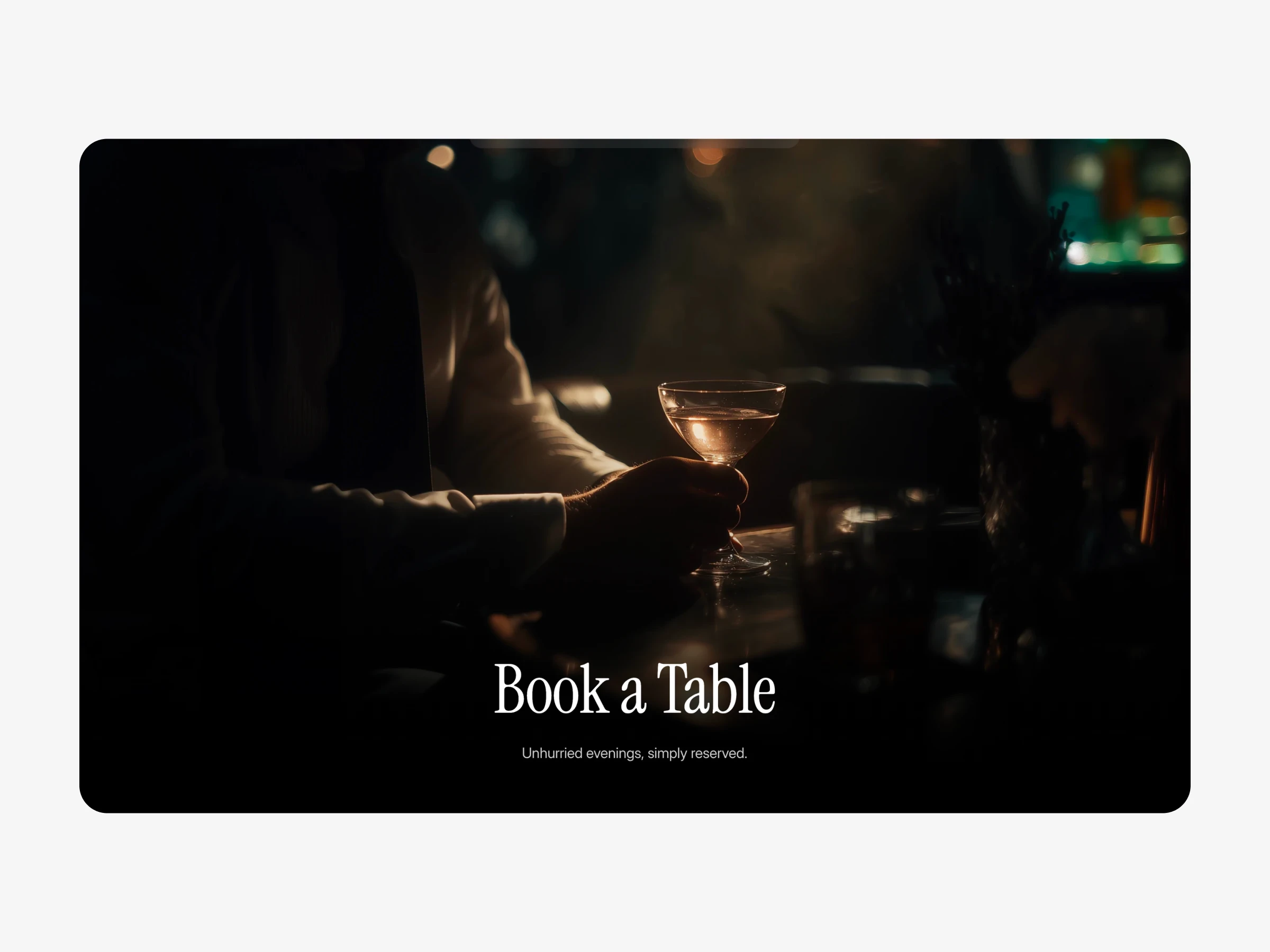 Dimly lit bar scene with a person holding a cocktail glass, used as a booking section image in a restaurant website template.