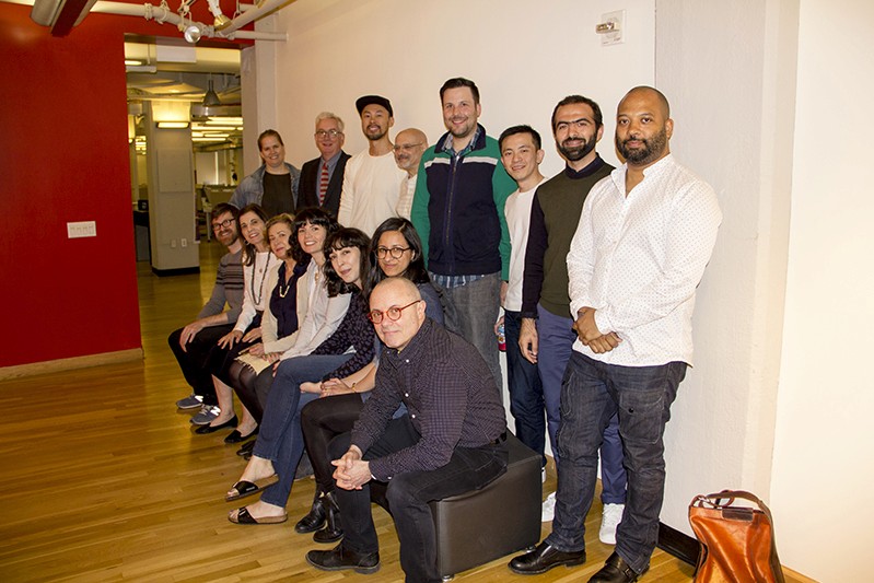 A photo of a group of people in an art exhibition room.