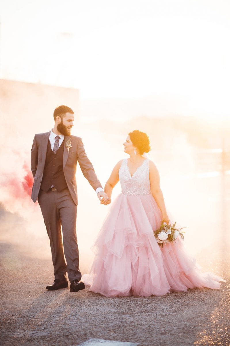 Bride and groom photographed at sunset