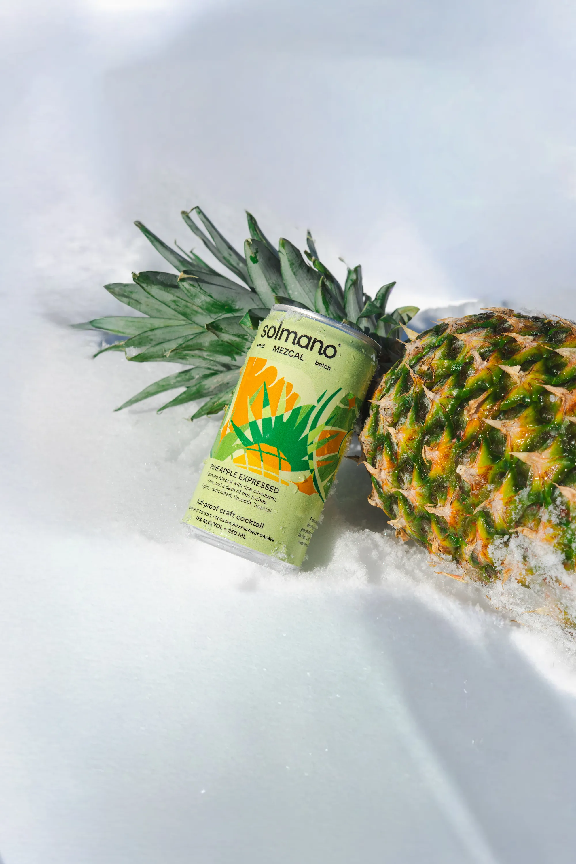Solmano Pineapple Expressed cocktail can nestled inside a fresh pineapple