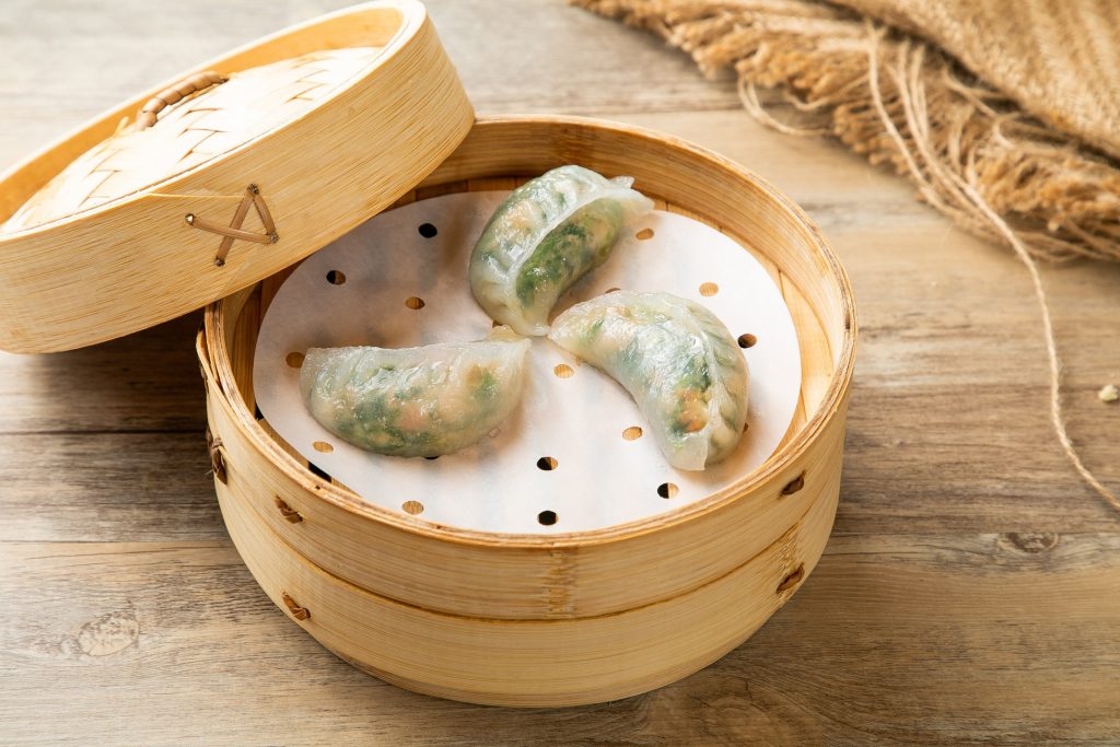 Delicate Tri-Tip Dumplings from Dum Sum Palace, highlighting their unique shape and savory filling, plated for a perfect dim sum experience.