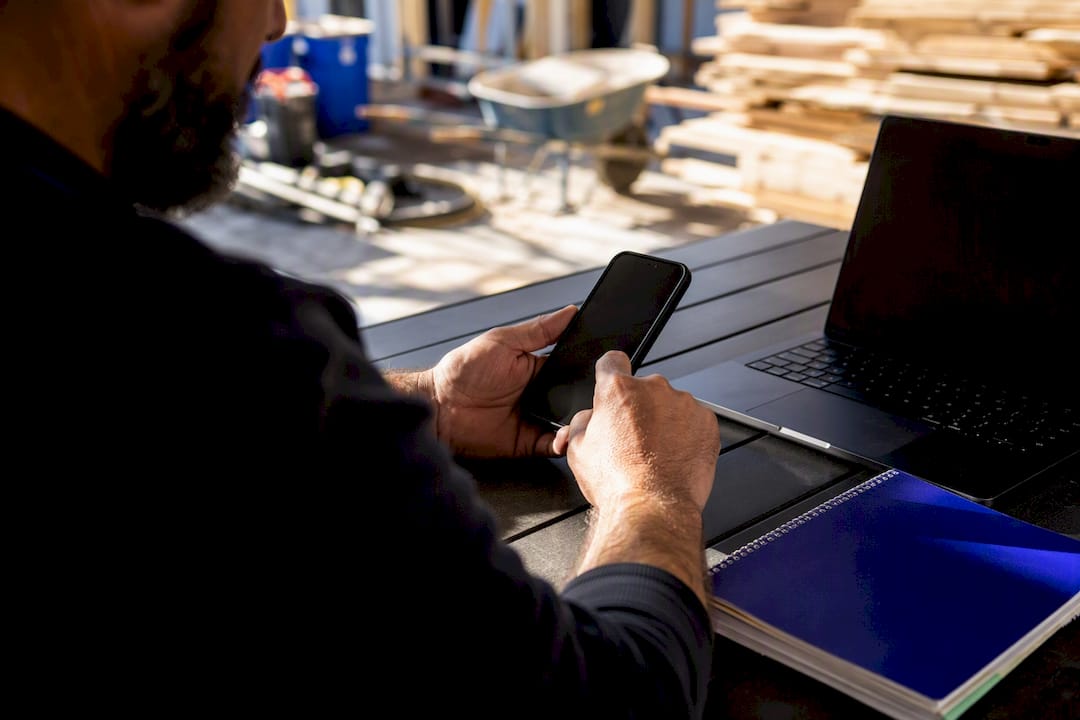 Hands adjusting smartphone to automate text templates