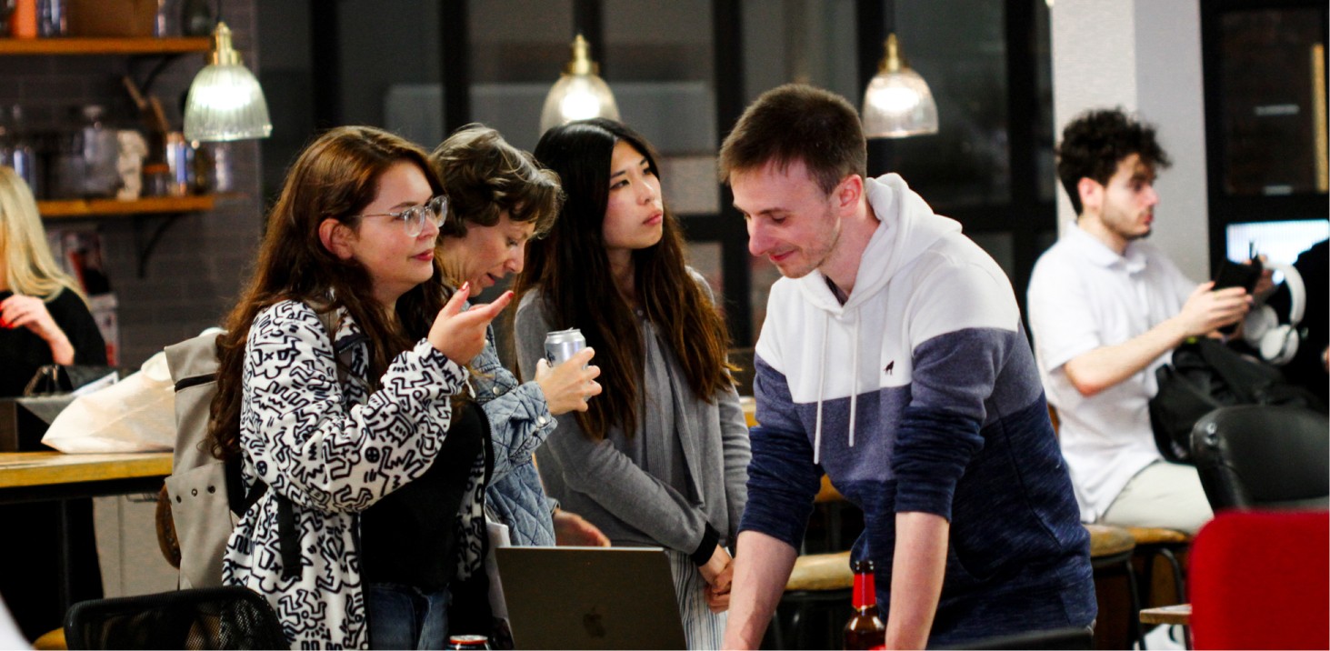 People standing and talking at a busy, open-mouthed place.