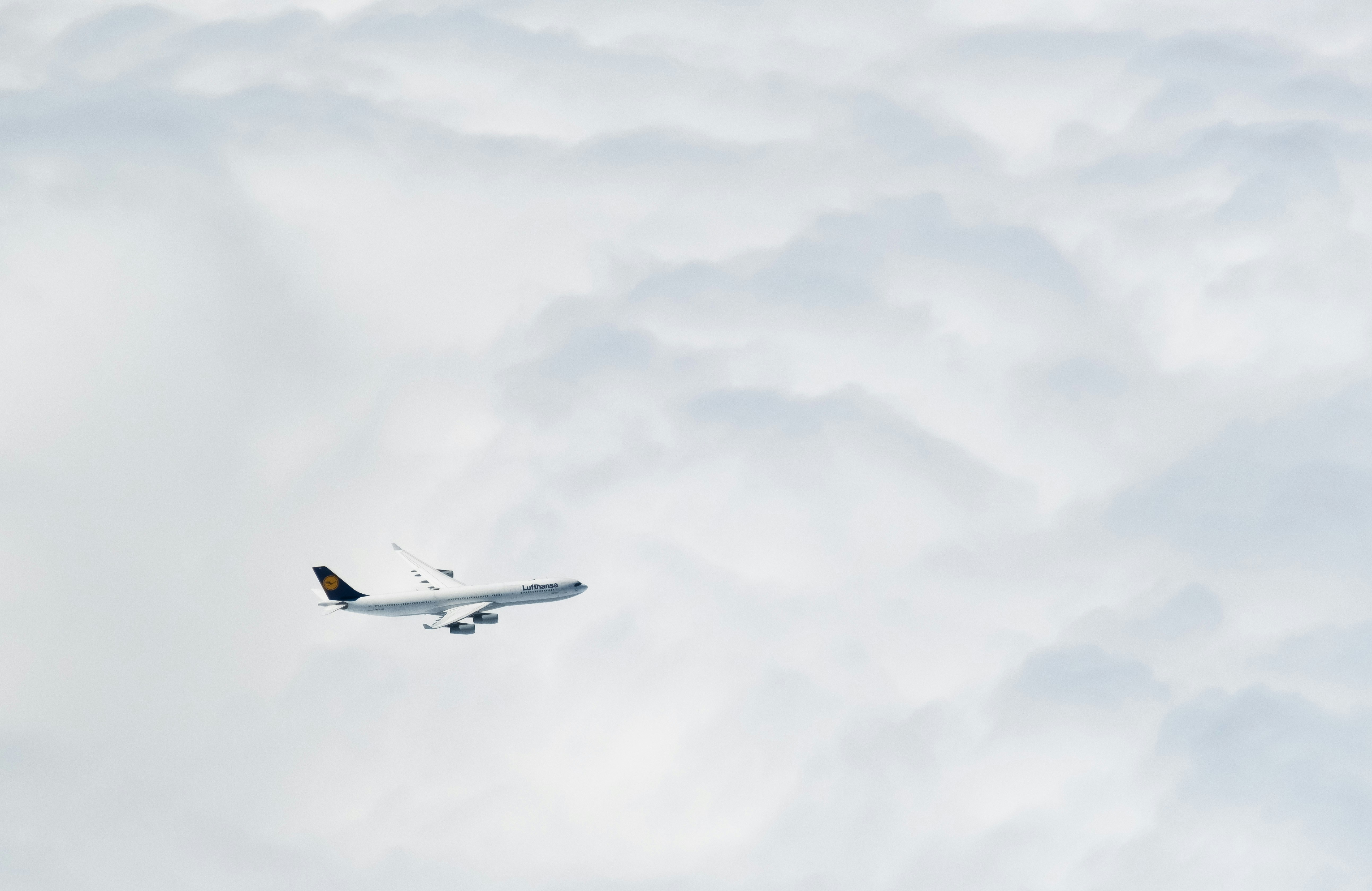 an airplane flying through the clouds in the sky