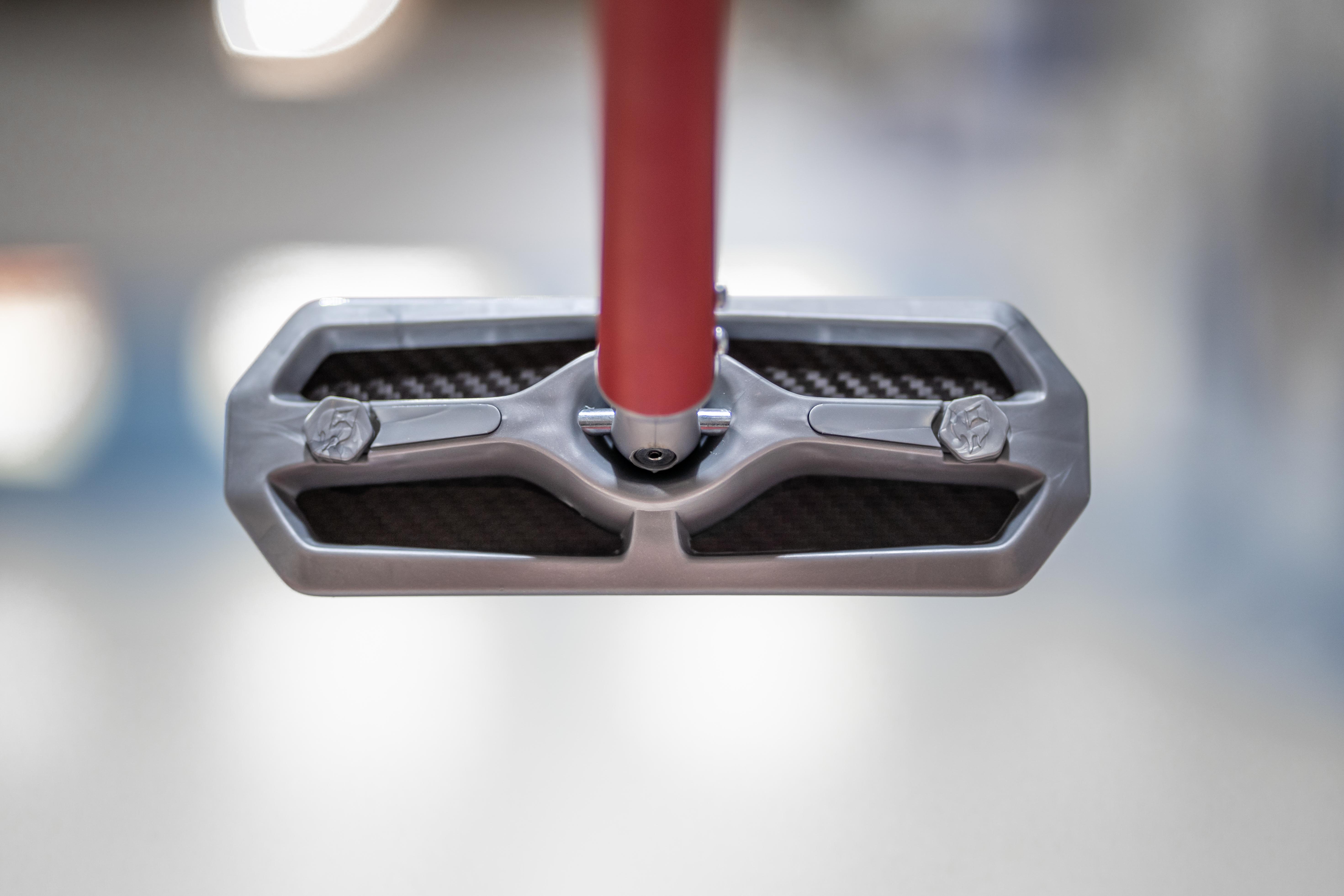 a close up picture of a silver curling broom head 