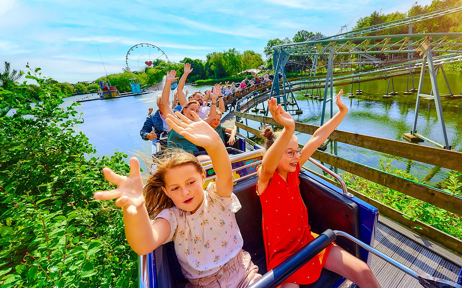 Kids enjoying a roller coaster ride at Bobbejaanland theme park.