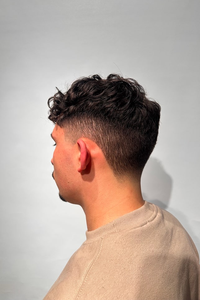 Tall, open restaurant venue with wood tables and chairs