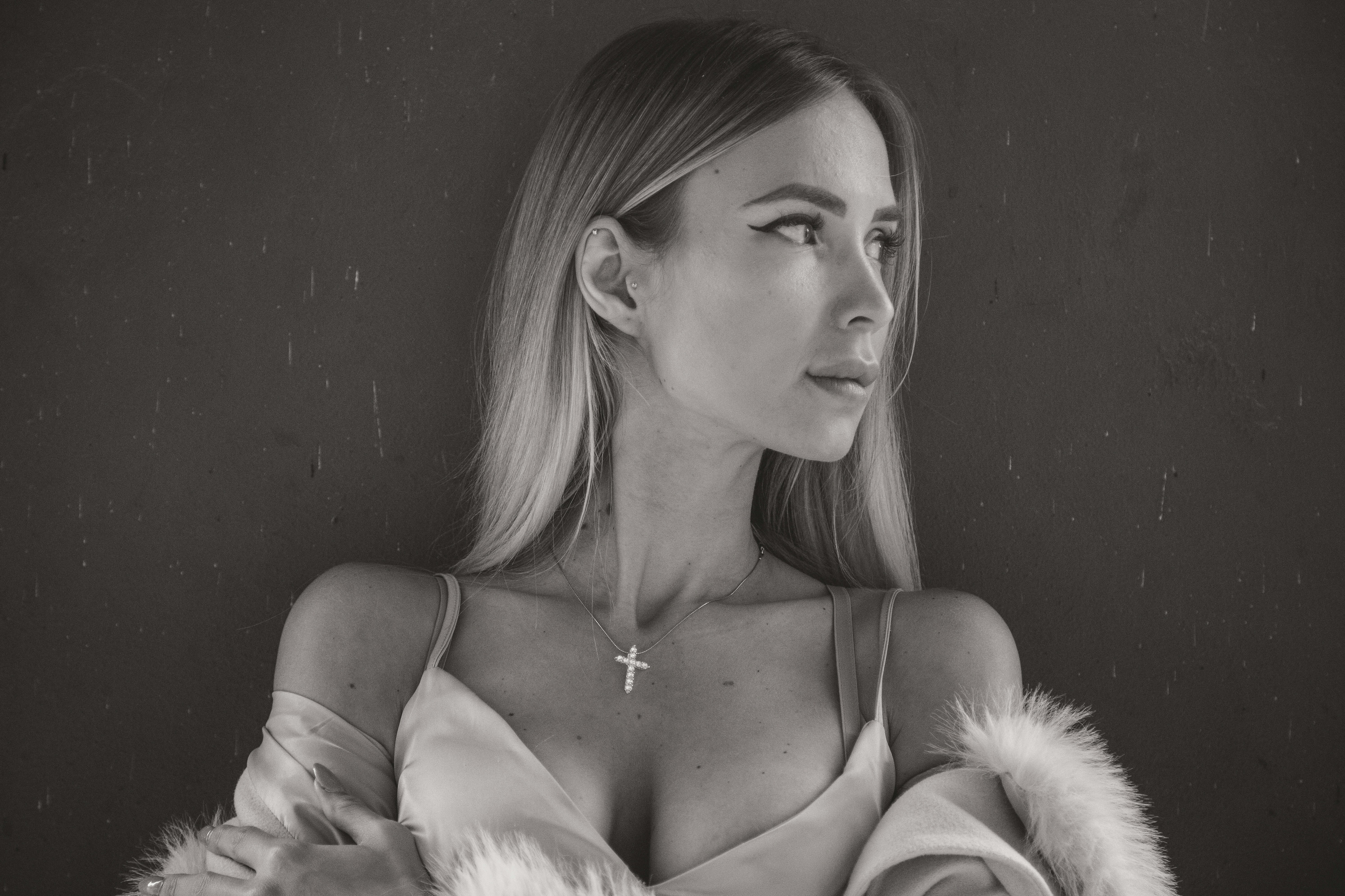 A black and white photo of a woman in a fur coat