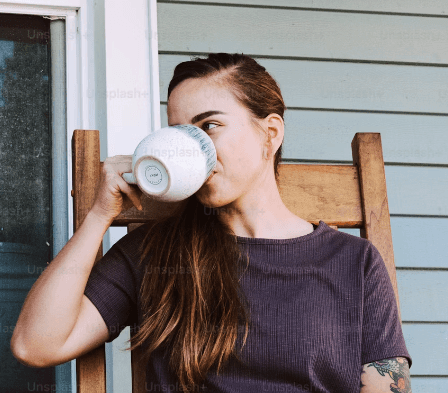 Shirtless man sipping espresso