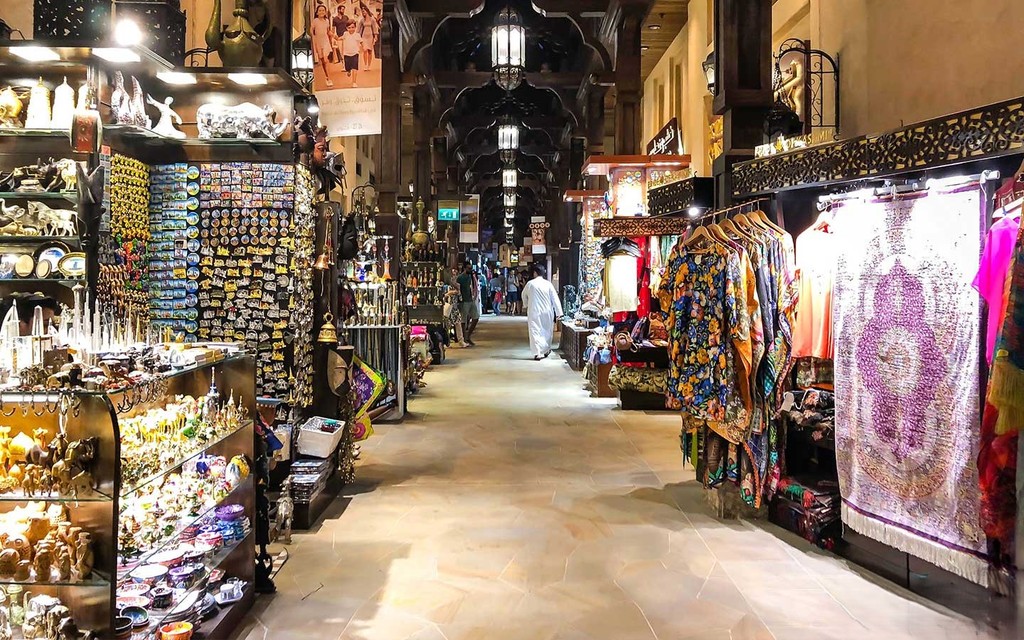 Narrow alleyway in Al Sufouh: various items on display, local culture, craftsmanship.