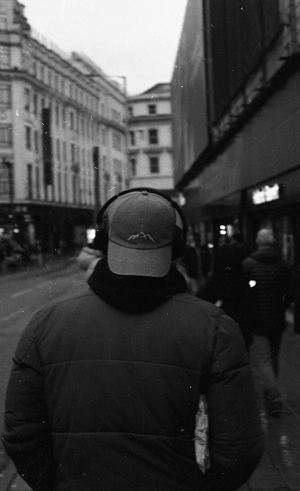 man walking through street