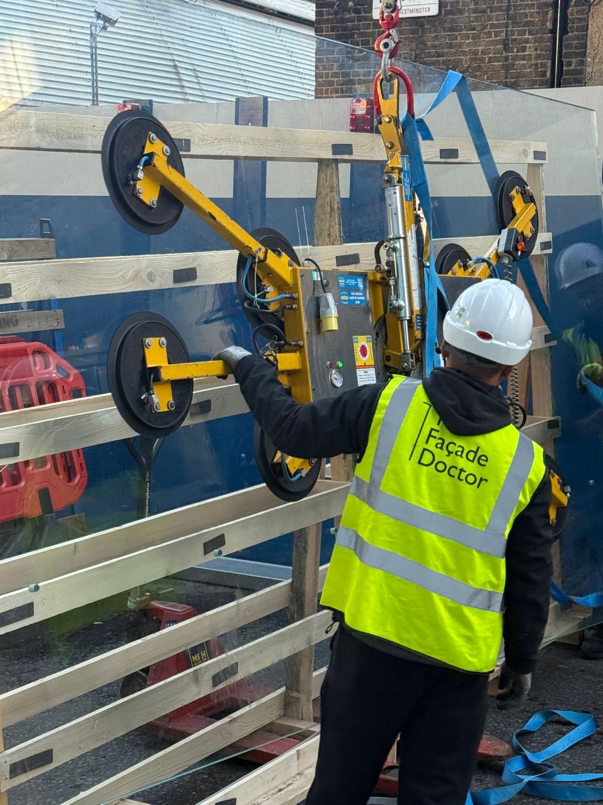 Glass panel handling with a vacuum lifting device