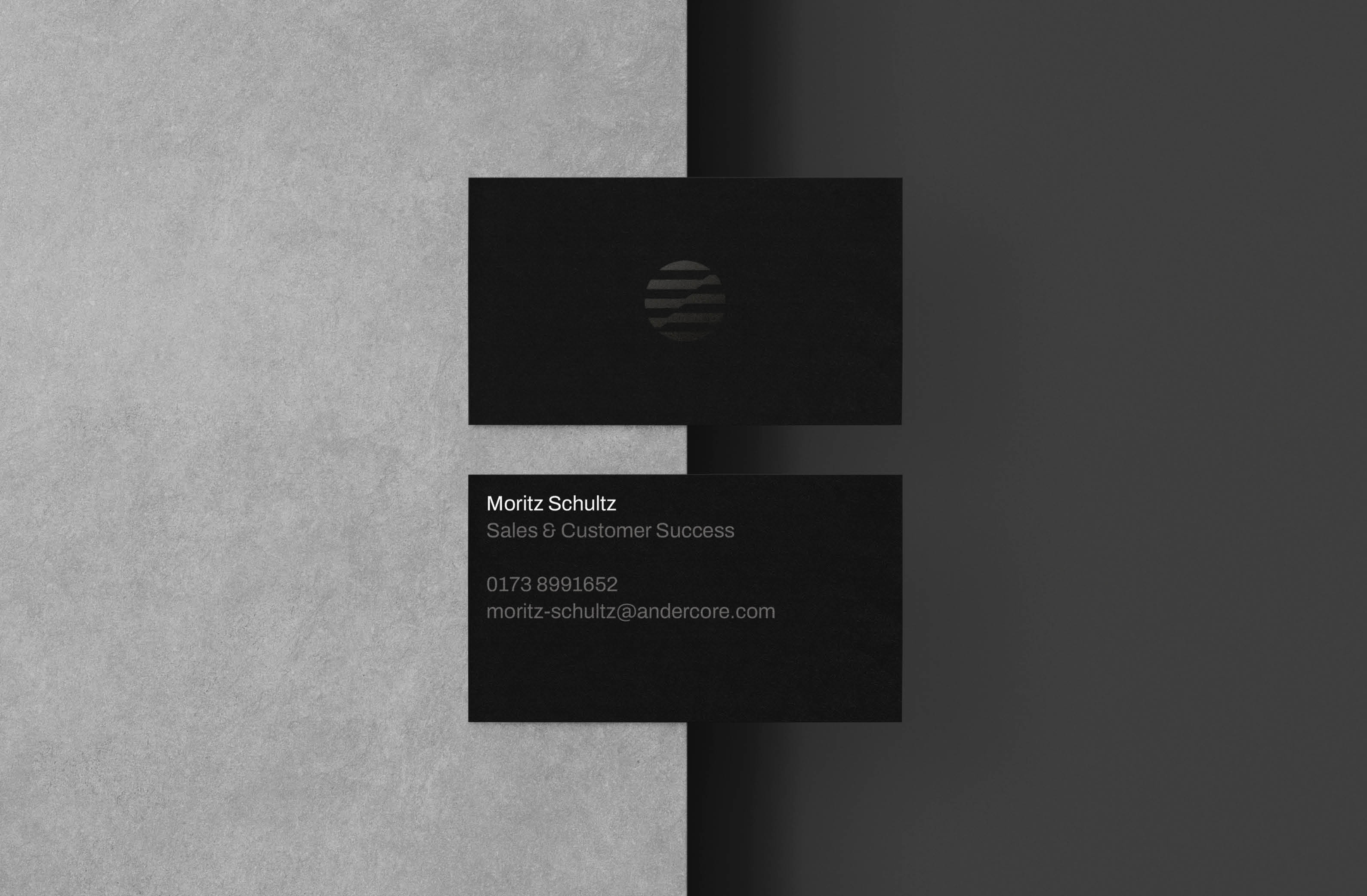Business cards featuring sleek black design for Andercore.