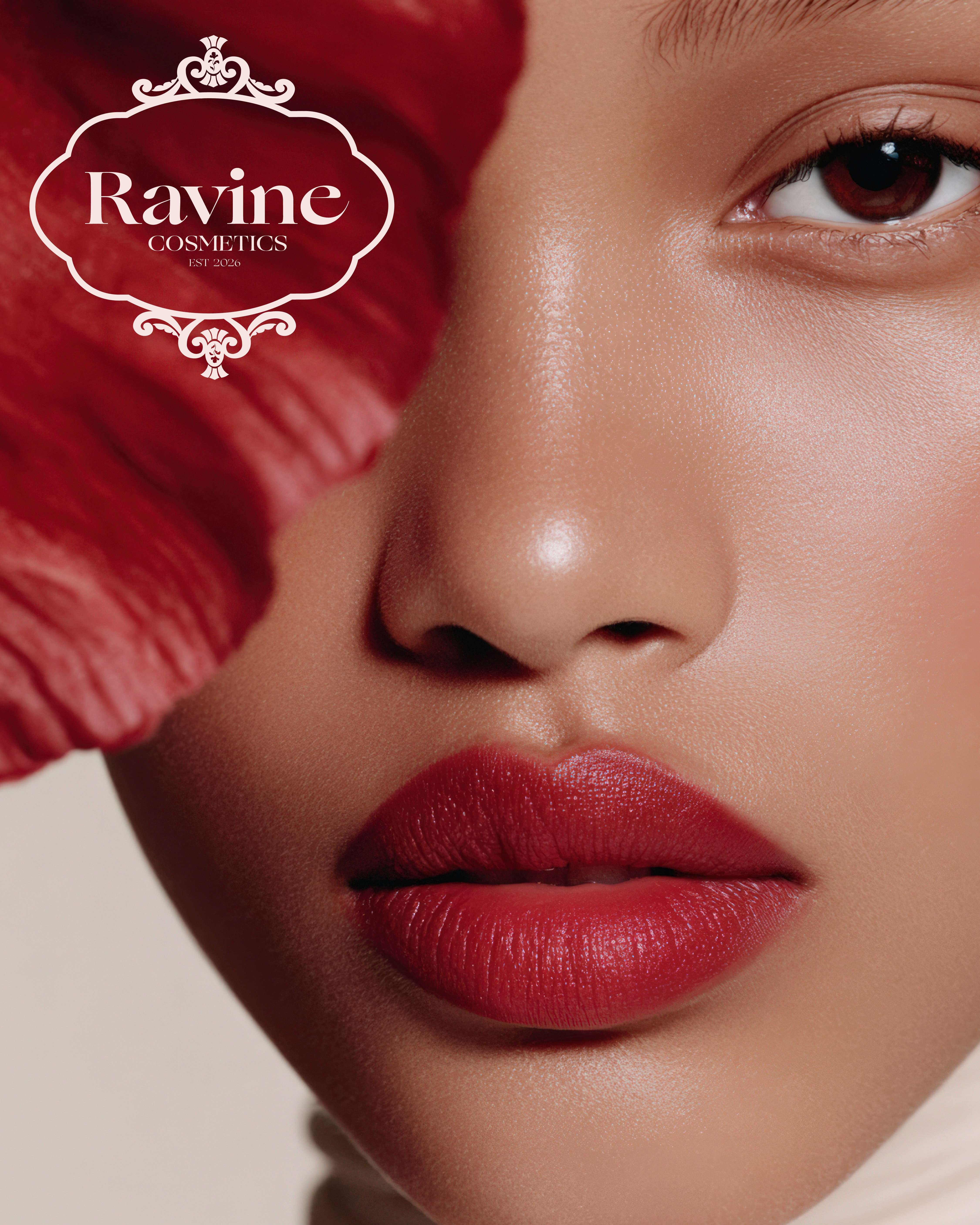 woman wearing lipstick holding a red flower covering one eye with the ravine logo on the upper left