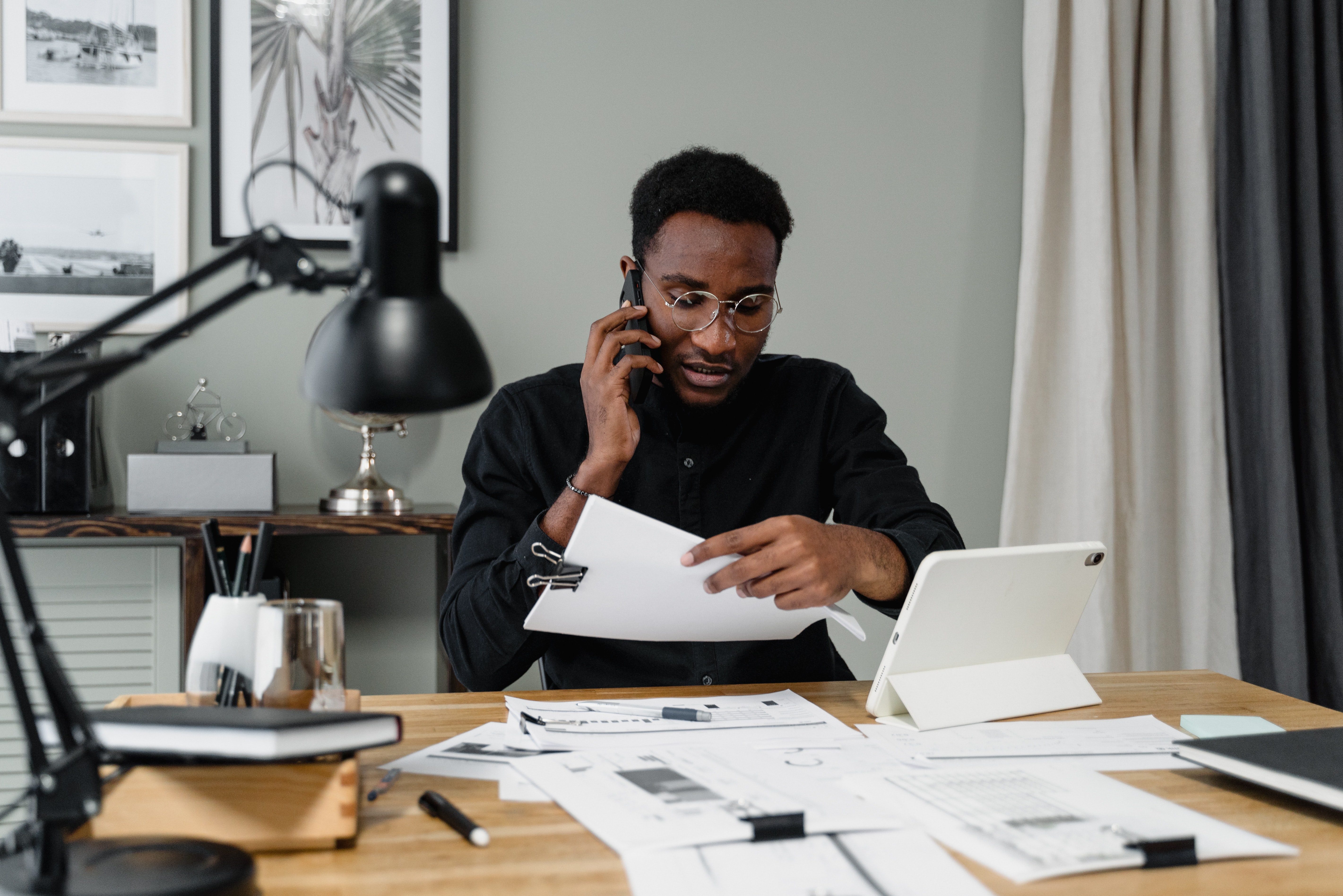 Service provider model on the phone holding paper at desk