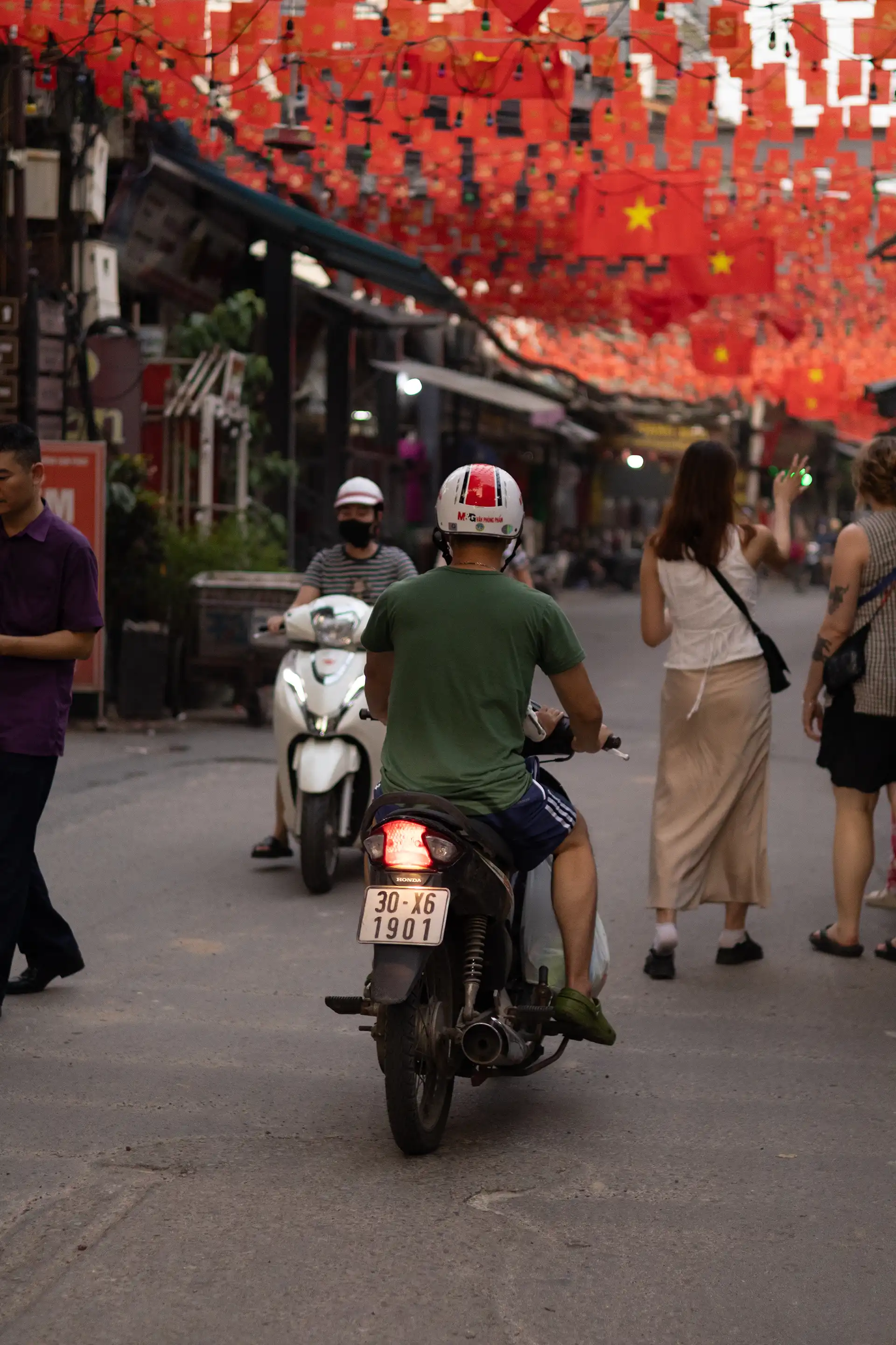 Person driving a scooter in the streets of Vietnam