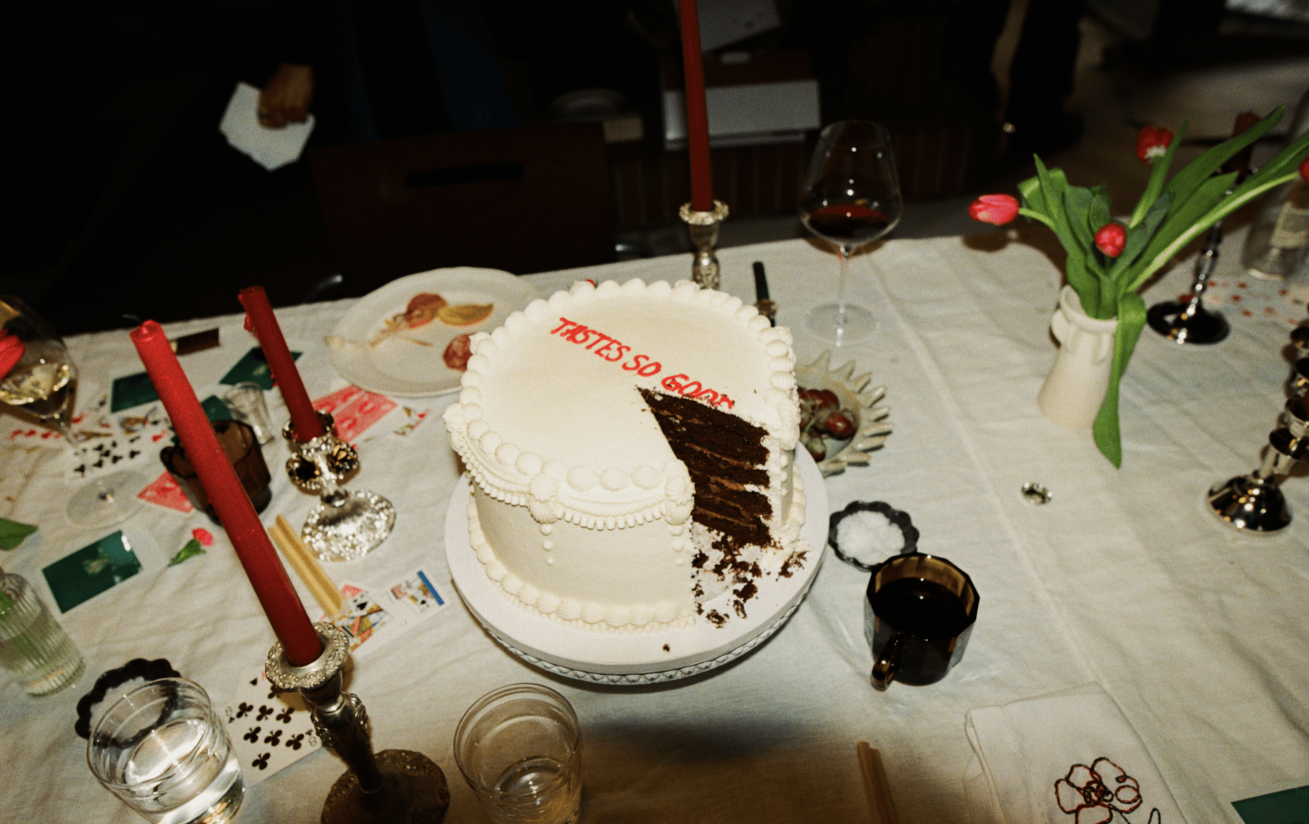 A decorative floral arrangement spills over a table draped in red fabric, creating an elegant atmosphere.
