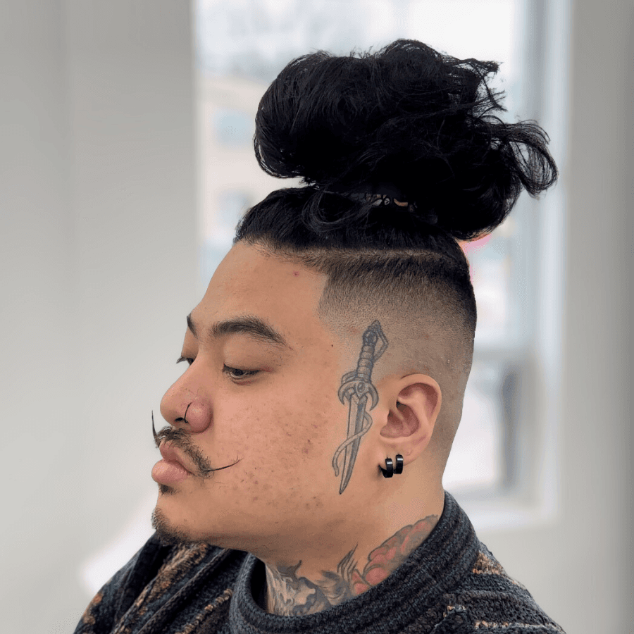 person holding white and gold hair comb