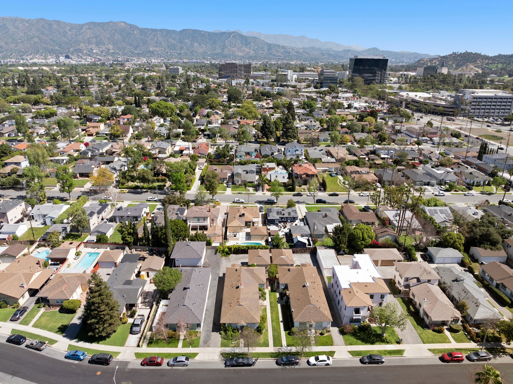Aerial neighborhood view with surrounding homes and proximity to studios near 242 N Cordova.