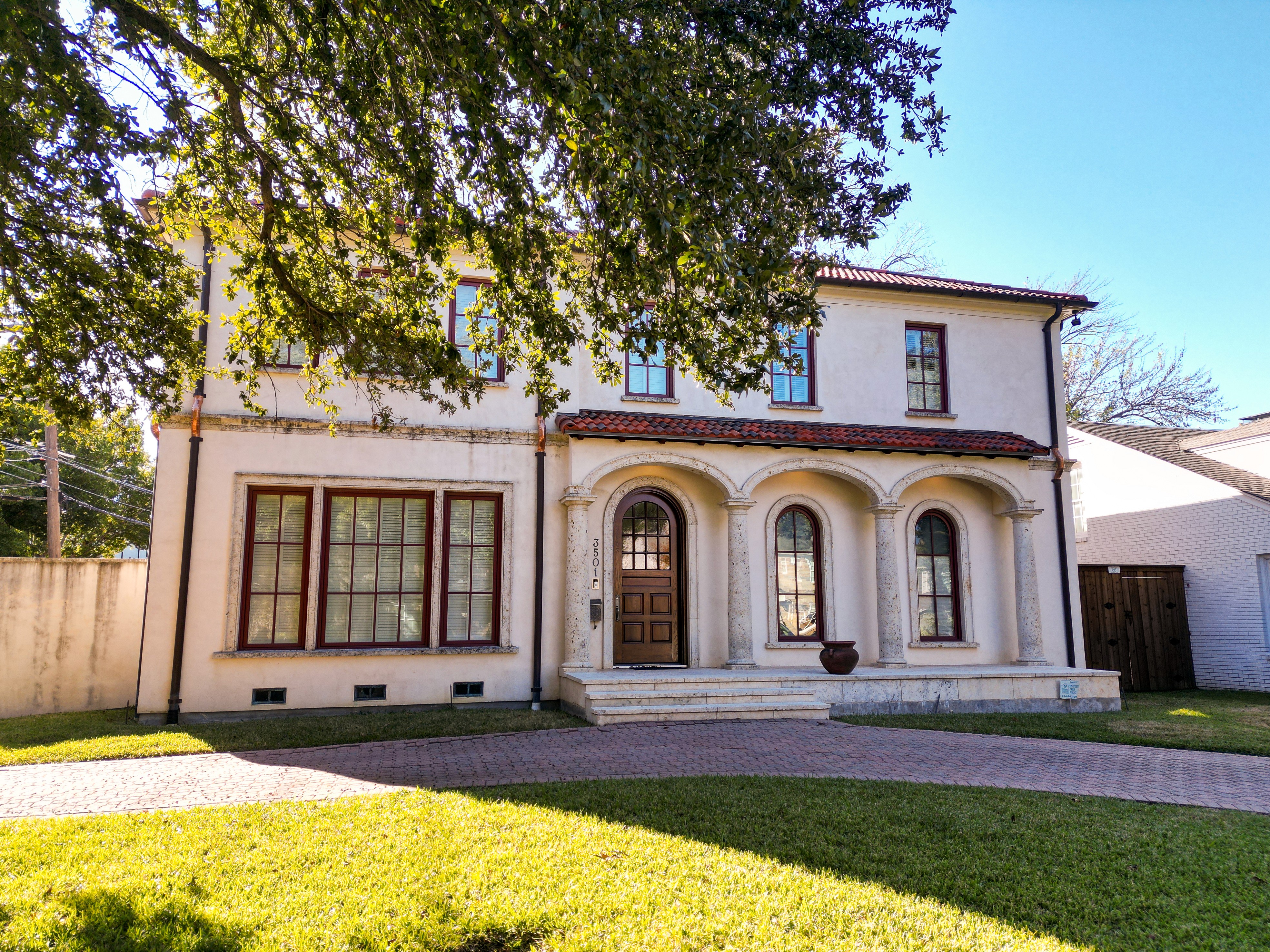 Mediterranean stucco home in University Park showing the new tile roof from the front