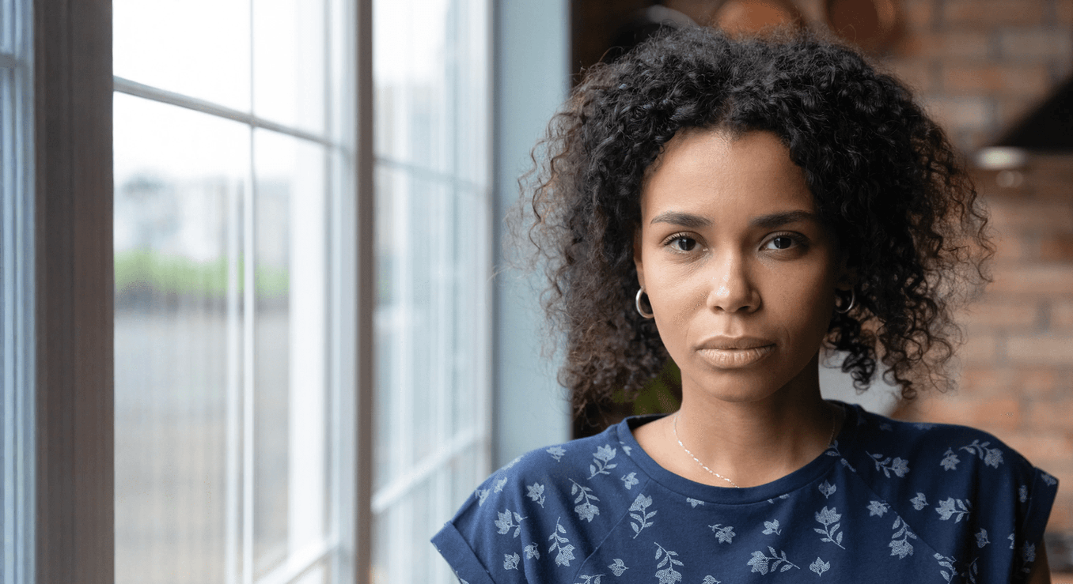 Photo of a yound black woman looking into the camera